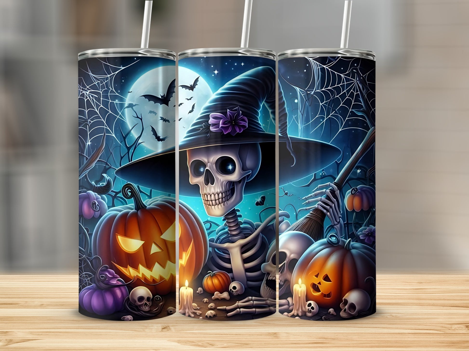 Three tumblers with Halloween skeletons, jack-o'-lanterns, bats, and spiderwebs.
