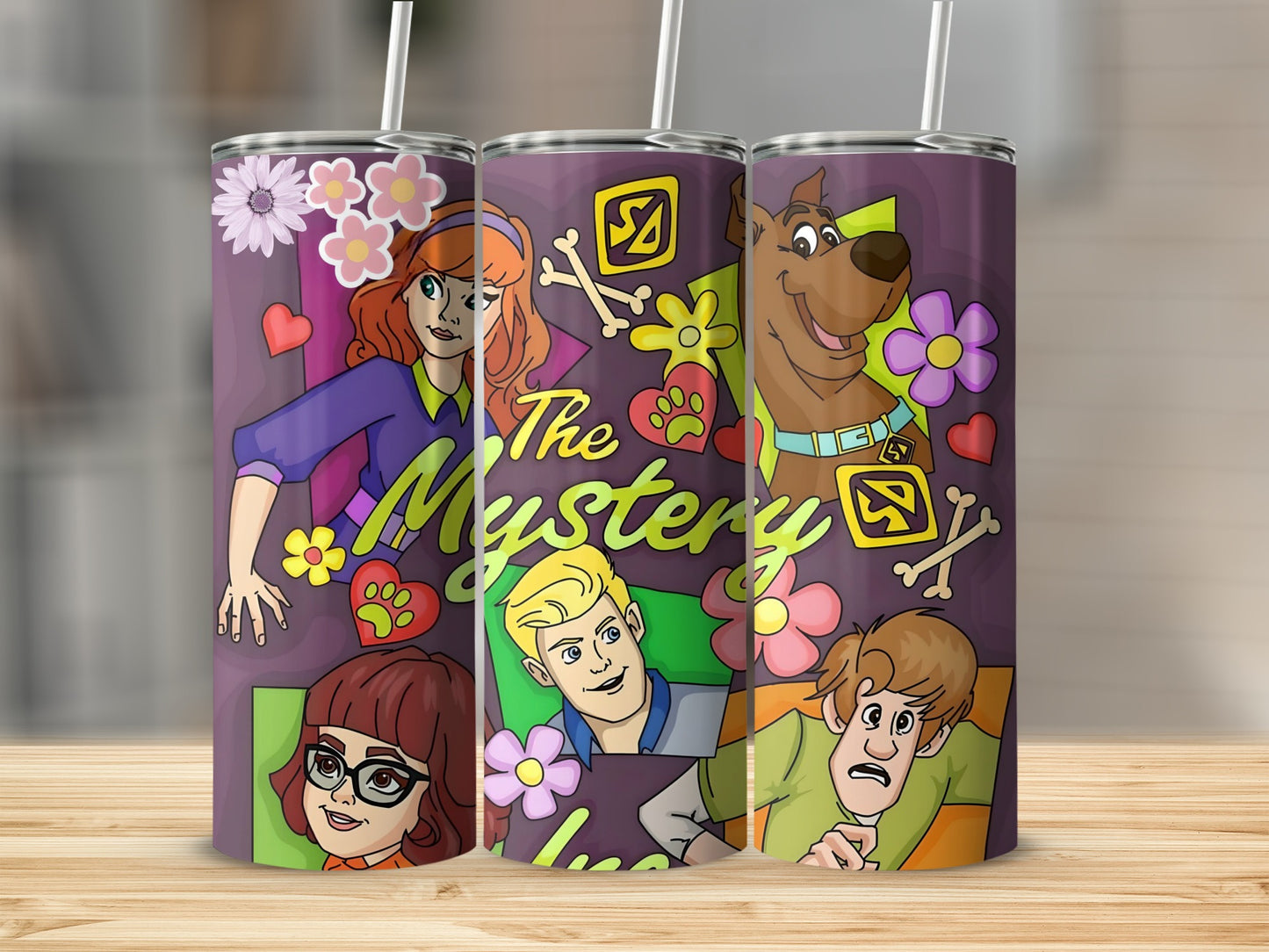 Scooby-Doo characters Fred, Daphne, Velma, Shaggy, and Scooby-Doo on a purple tumbler.