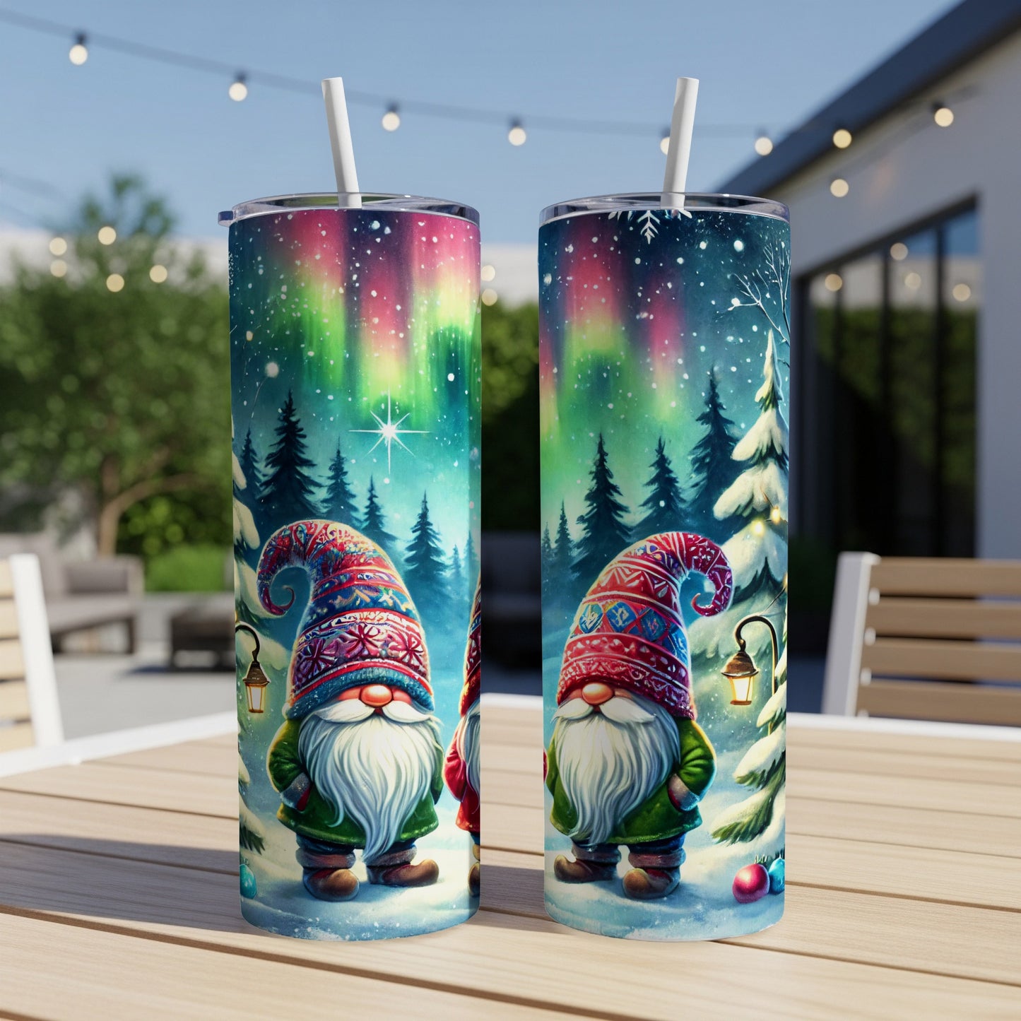 Two gnomes in Santa hats stand under the Northern Lights and snow-covered trees.