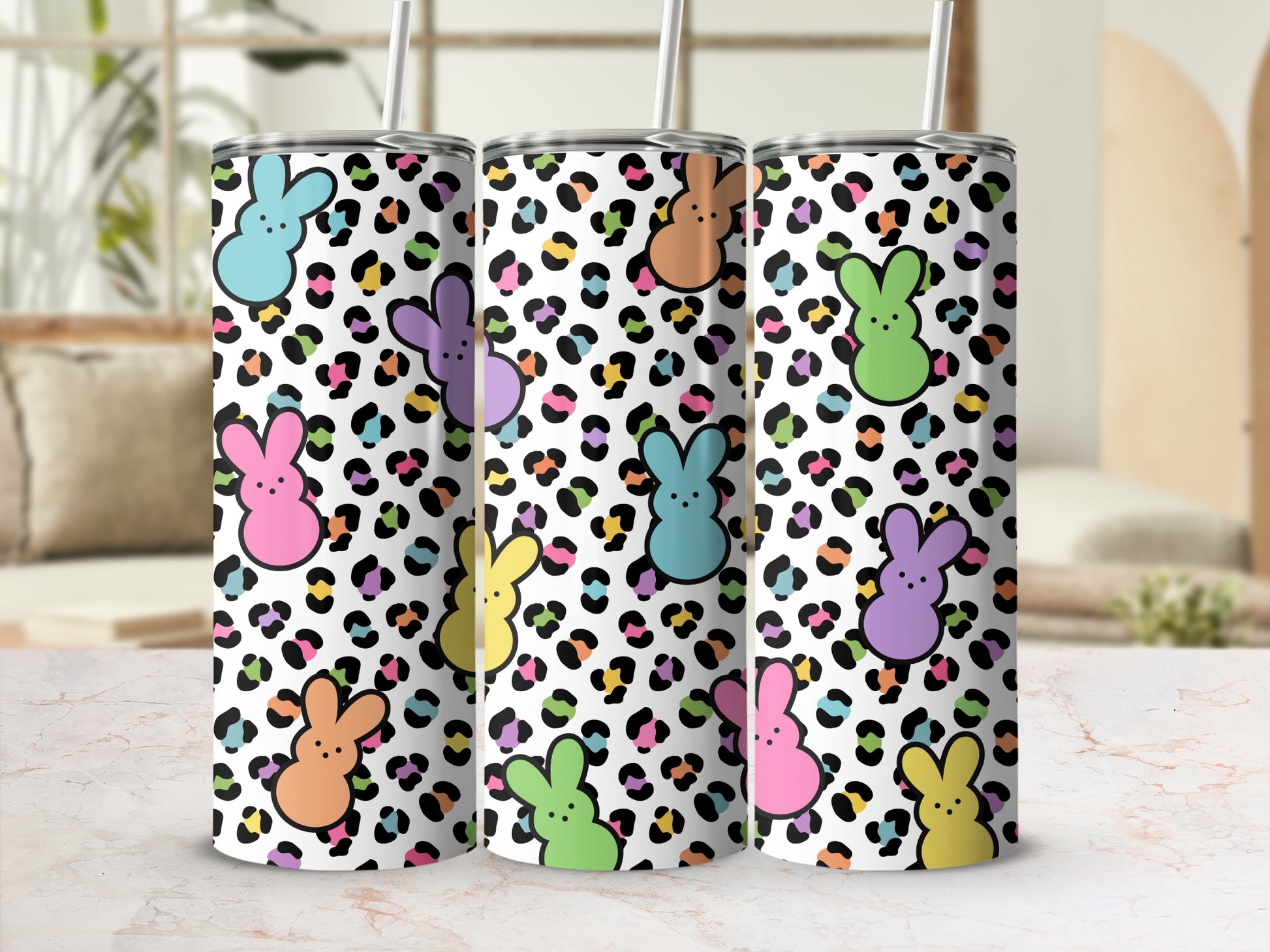 Pastel bunny silhouettes on a white leopard print tumbler with straws.