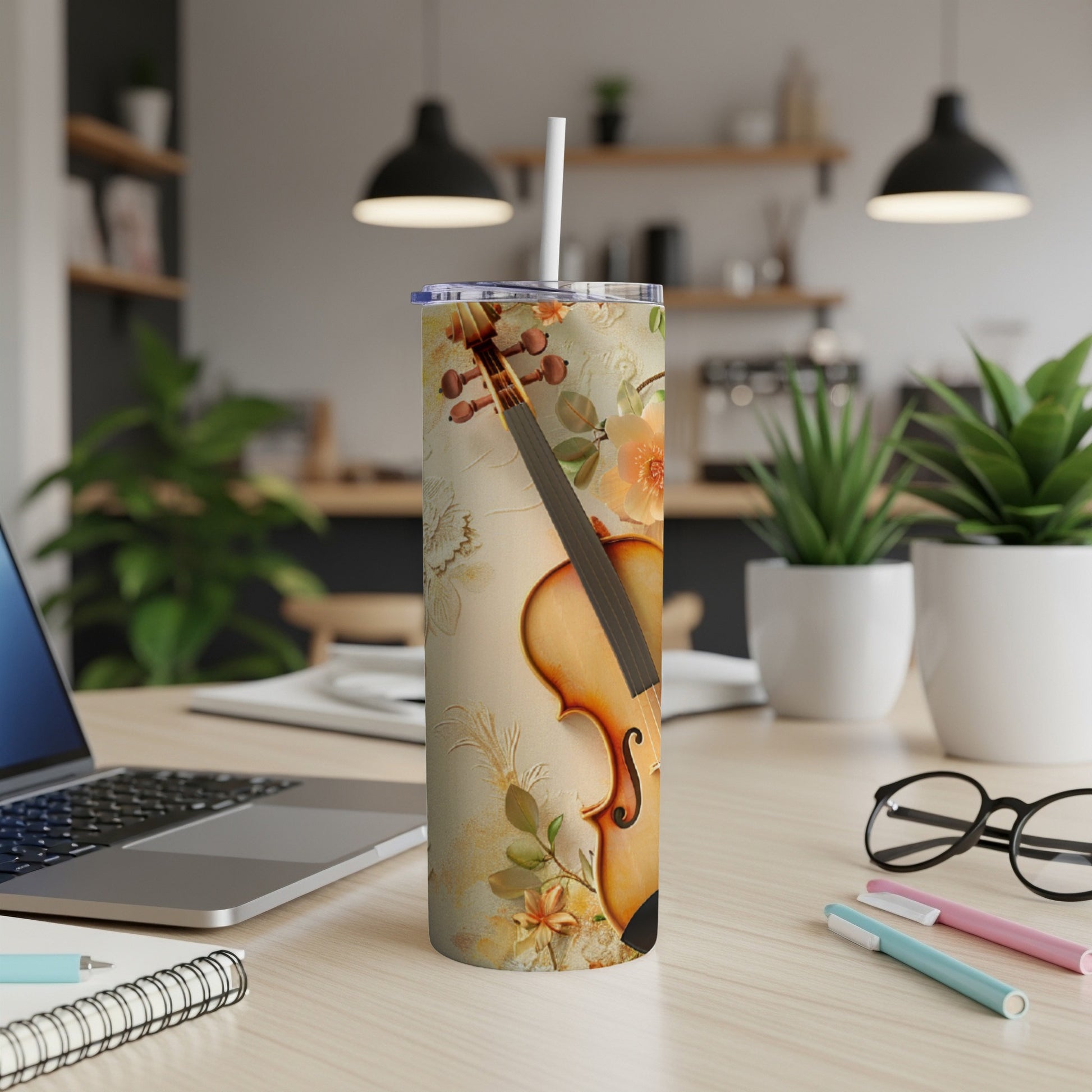 Violin on a tan patterned tumbler with floral accents and a straw.