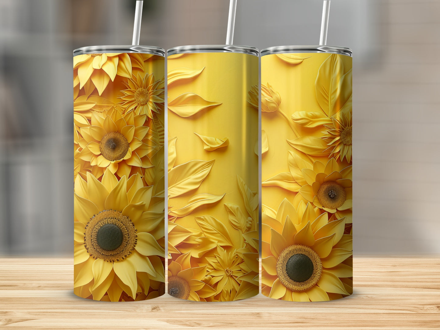 Three yellow tumblers with sunflower and leaf pattern on a wooden surface.