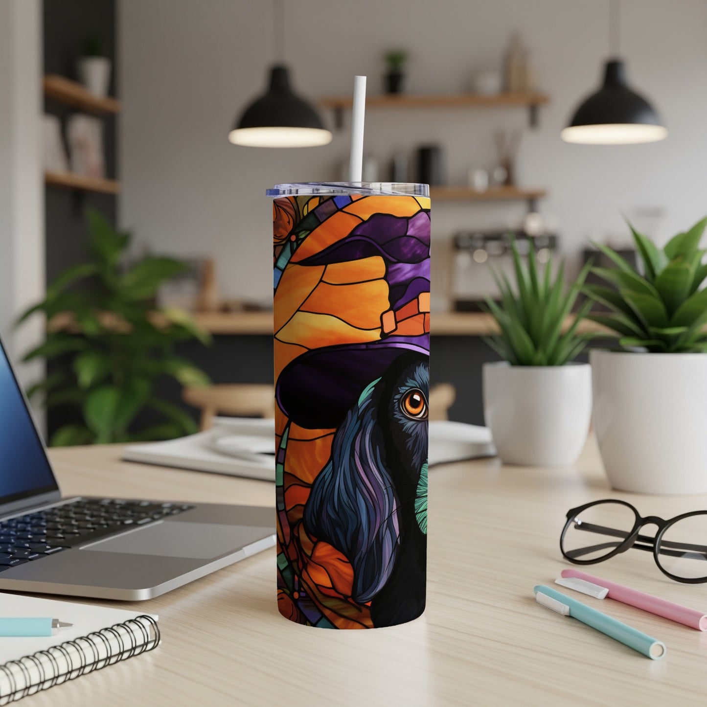 Black dog in witch hat with stained glass design on a tumbler.