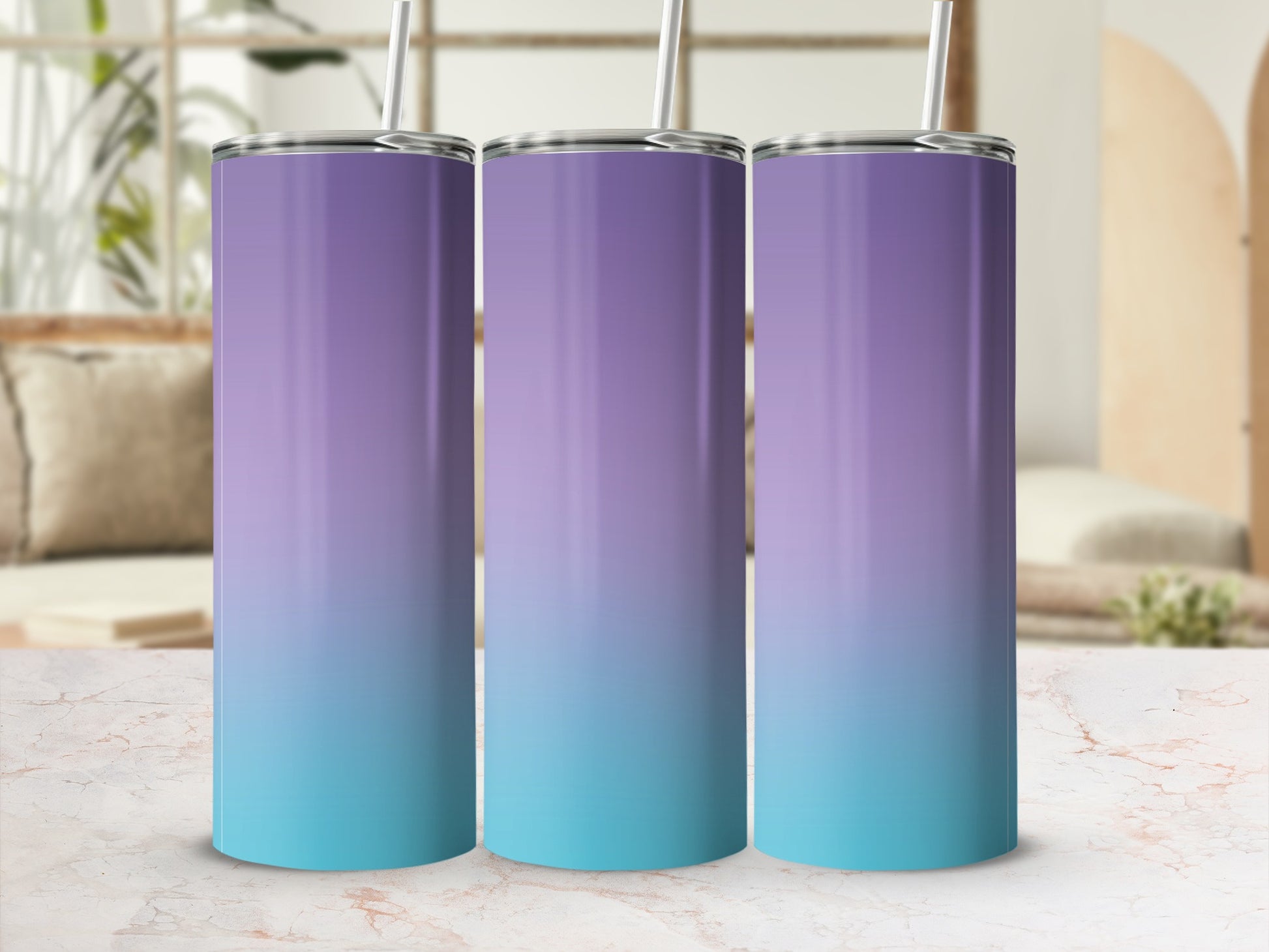 Three gradient tumblers, purple to teal, with straws, on a marble surface.