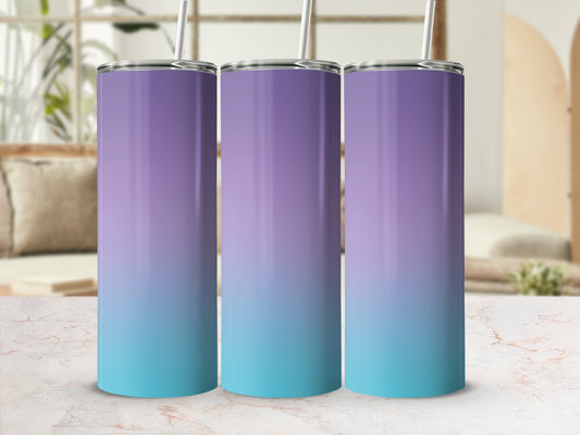 Three gradient tumblers, purple to teal, with straws, on a marble surface.