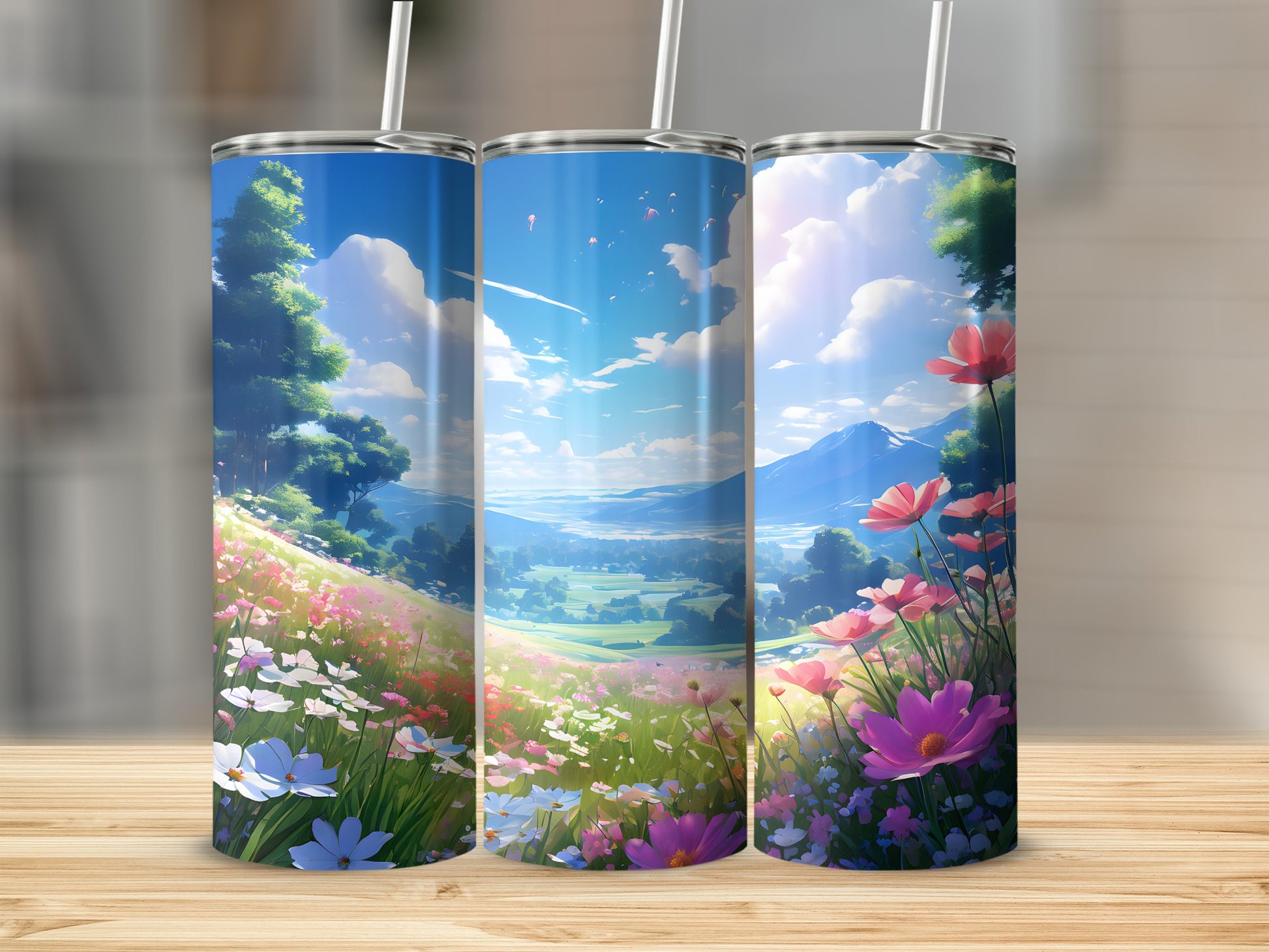Three tumblers with a scenic landscape of rolling hills, flowers, and mountains.