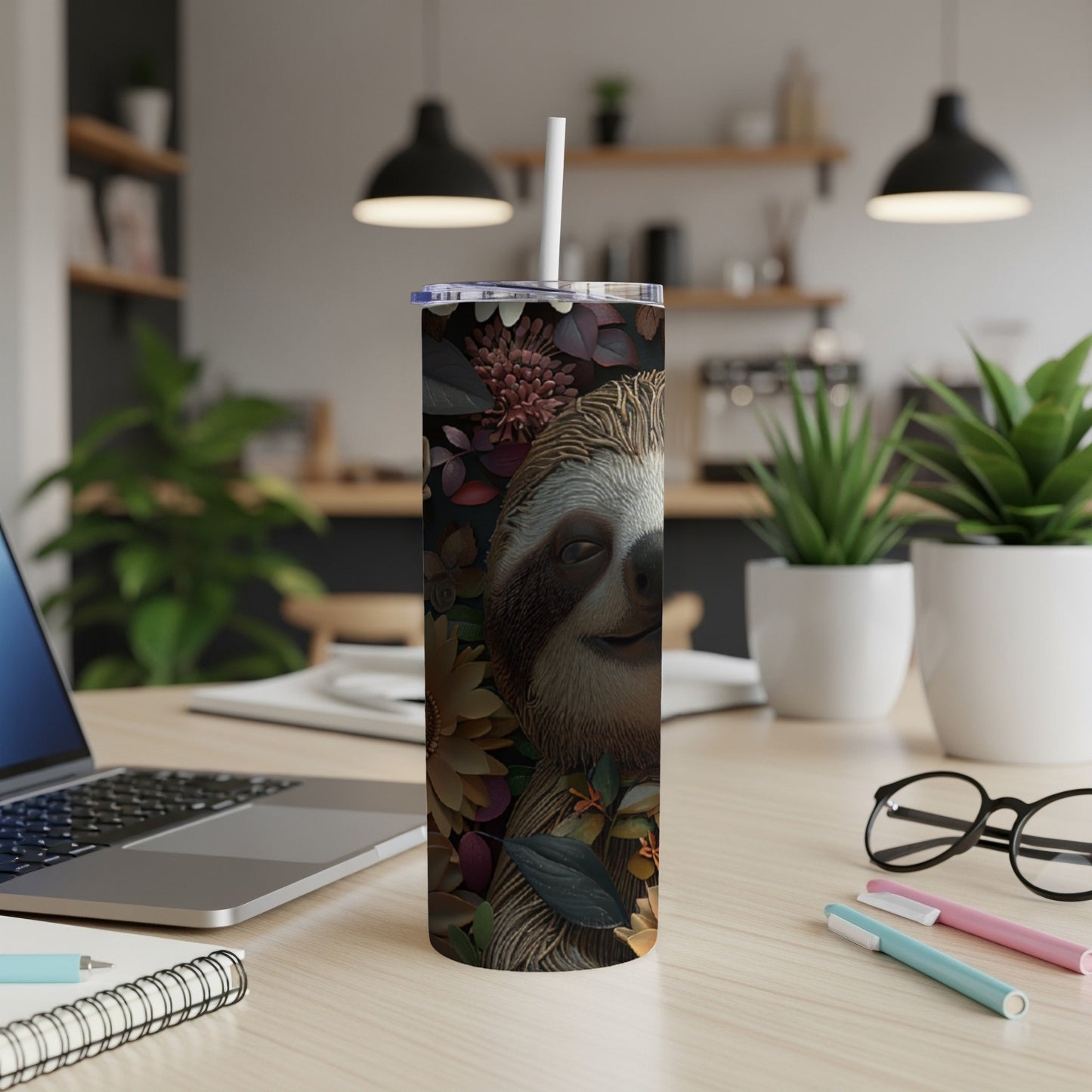 Tumbler featuring a sloth face surrounded by colorful flowers and leaves.