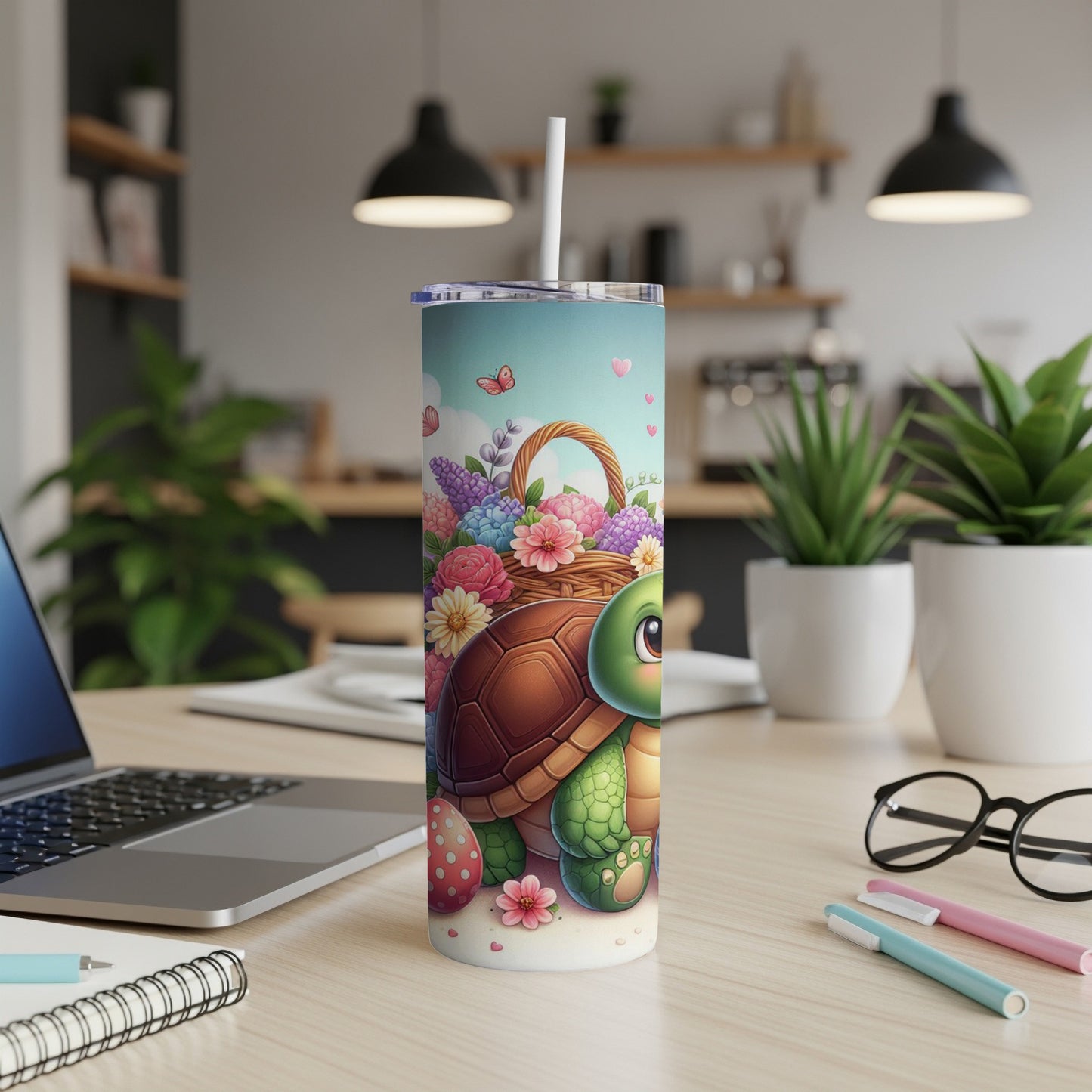 Turtle on a pink tumbler with a straw, surrounded by flowers and Easter eggs.