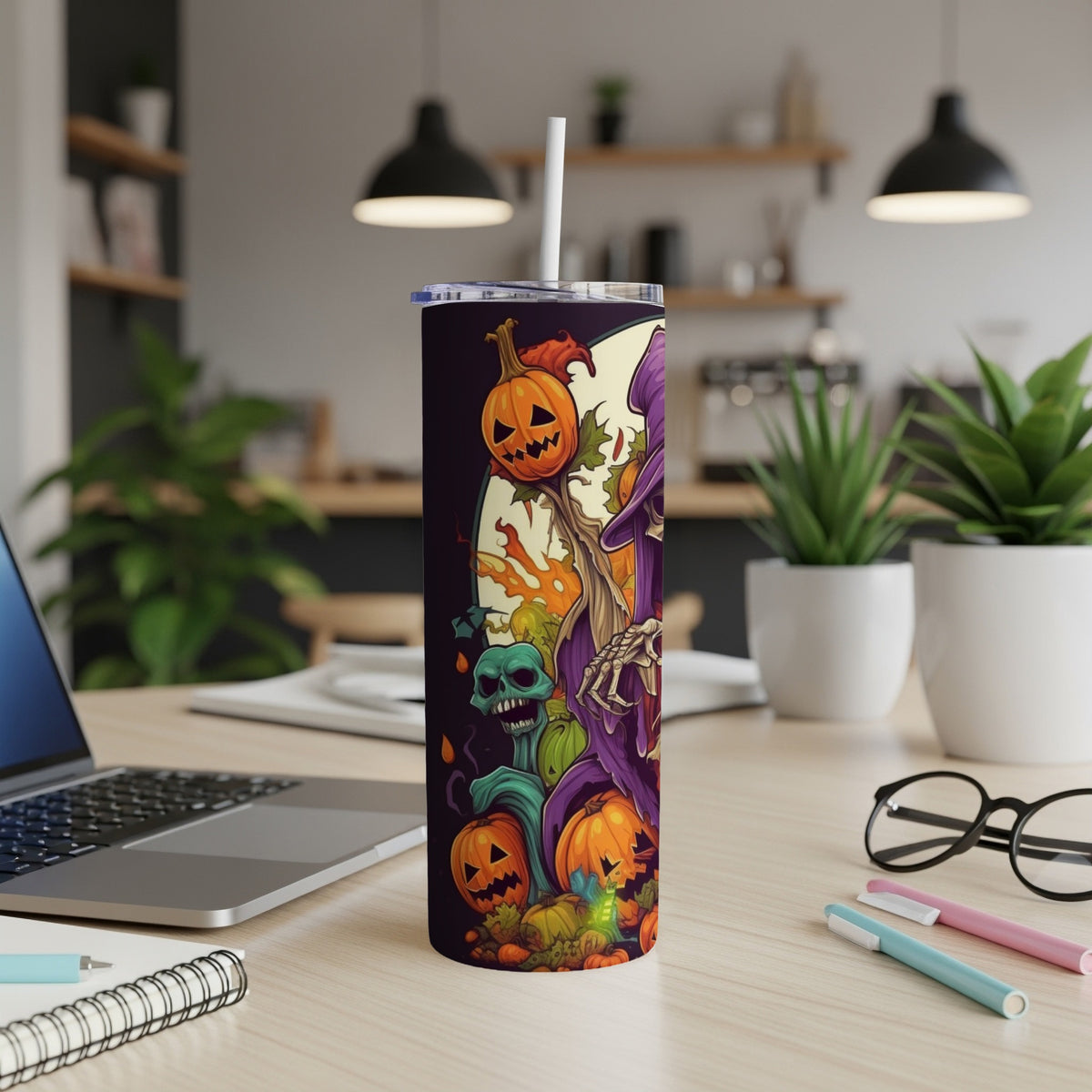 Halloween tumbler with pumpkins, skull, and witch graphic.