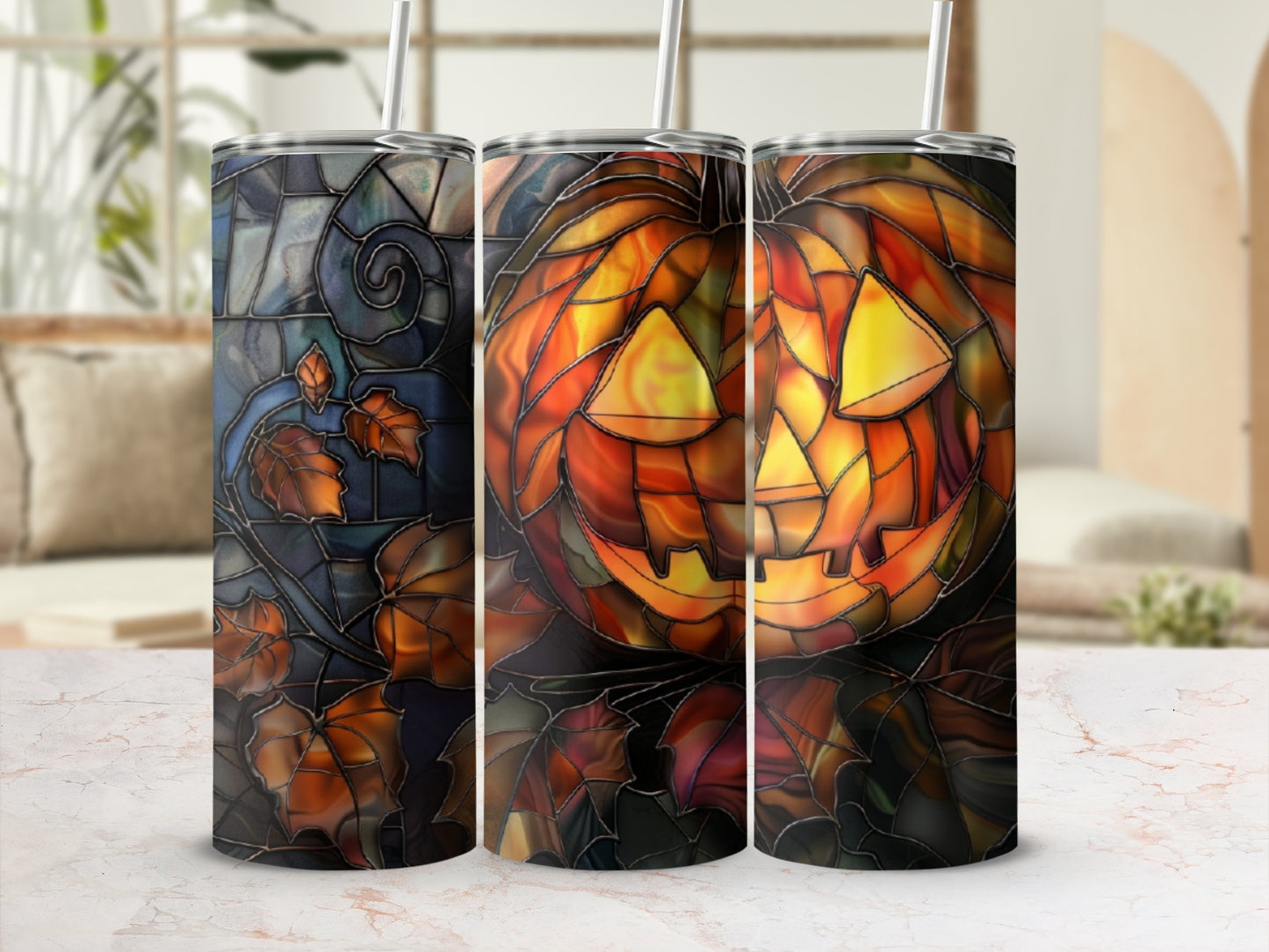 Three stained glass tumblers with Halloween pumpkin and leaf designs.