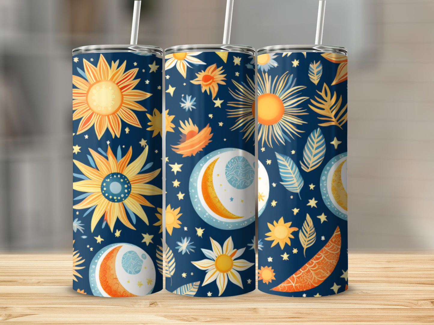 Three tall tumblers with suns, moons, and celestial patterns.