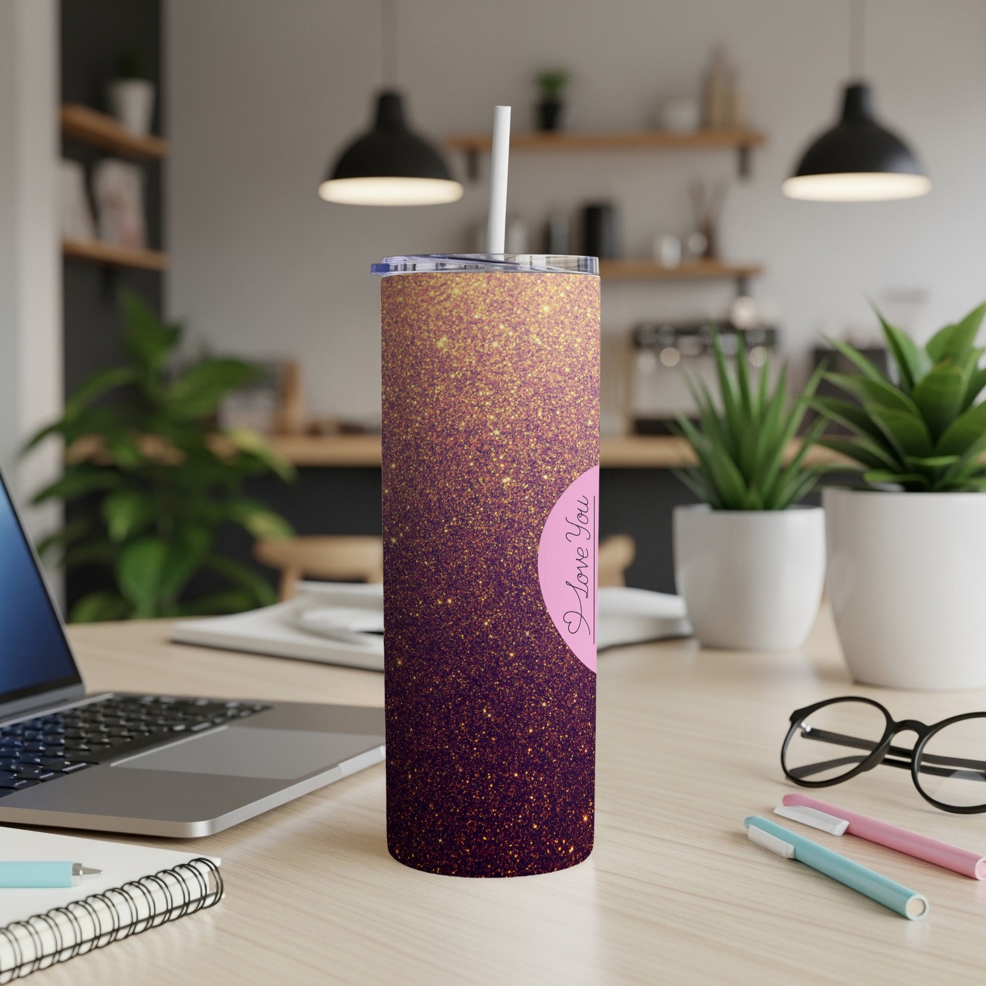 Glittery pink tumbler with "I Love You" text, angled on a desk.