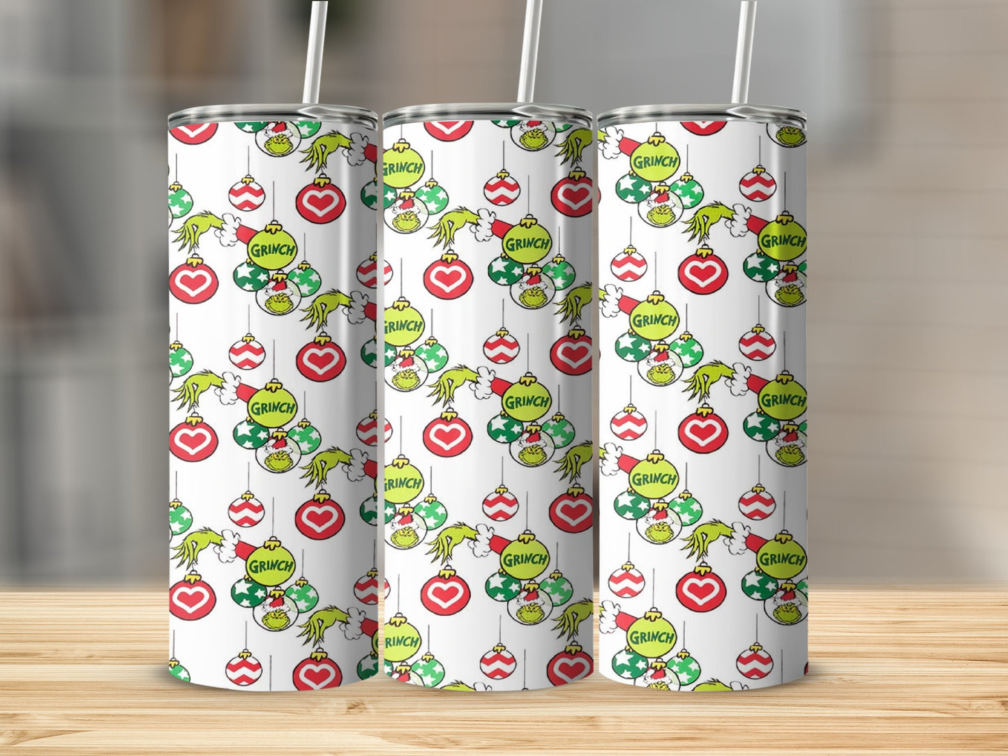 Three white tumblers with a repeating Grinch and Christmas ornament pattern.