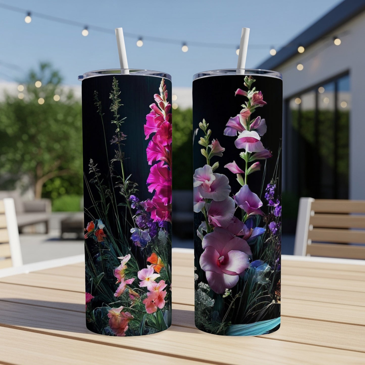 Two tumblers with vibrant floral designs on a dark background.