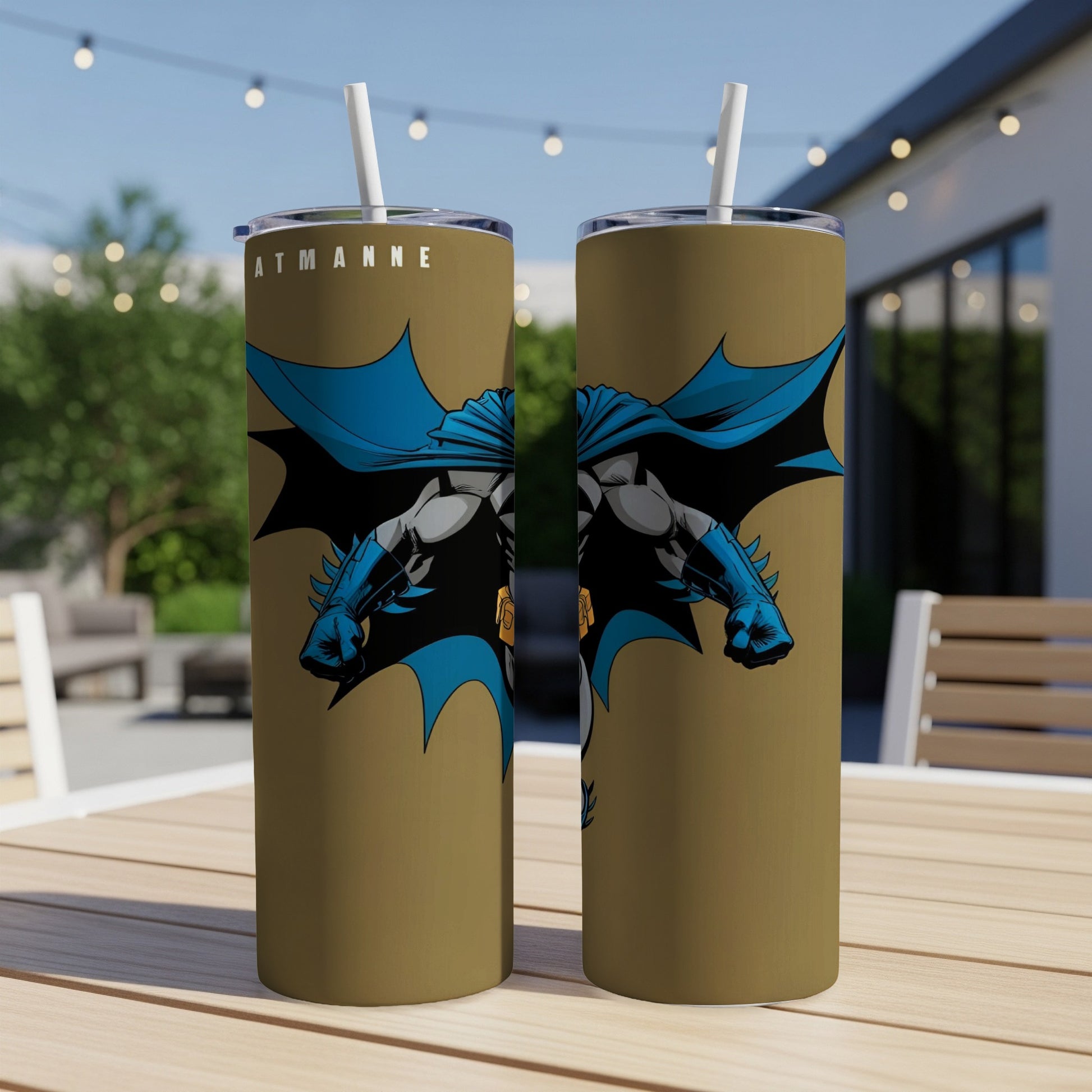 Two gold tumblers featuring Batman with blue cape, straw in each.