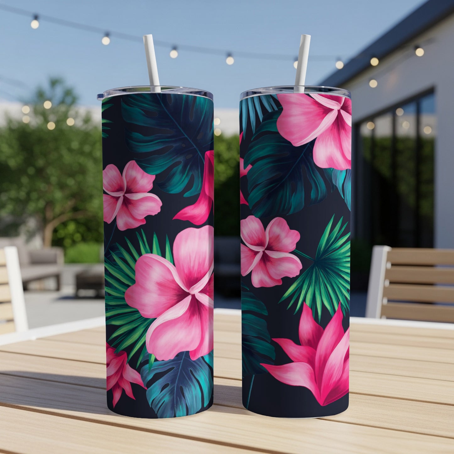 Two tumblers with pink tropical flowers and dark green leaves.