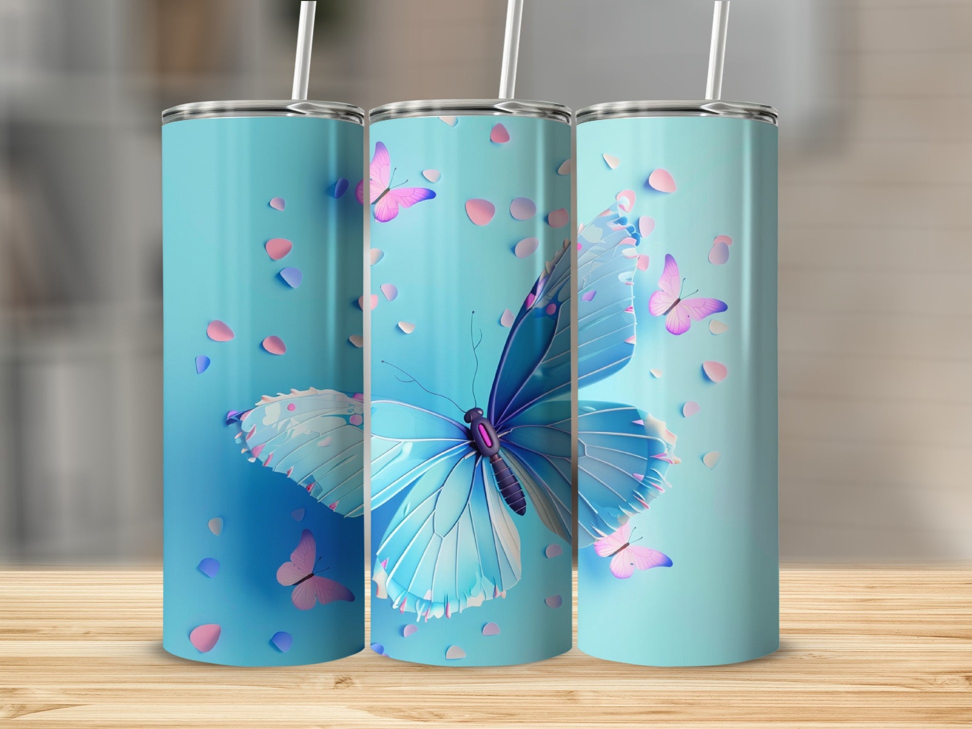 Three teal tumblers with blue butterflies and pink petals.