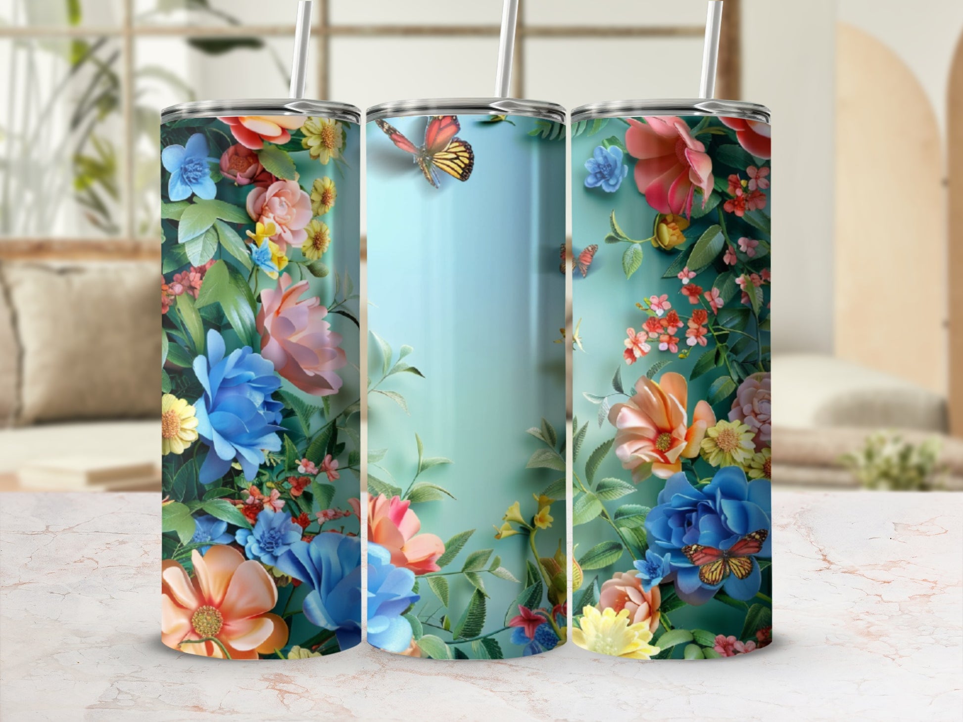 Three tall tumblers adorned with vibrant floral patterns and butterflies.