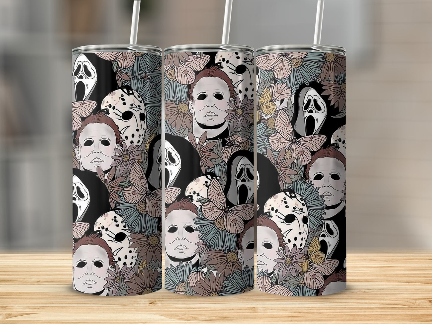 Tumbler with a repeating pattern of horror movie villains and floral elements.