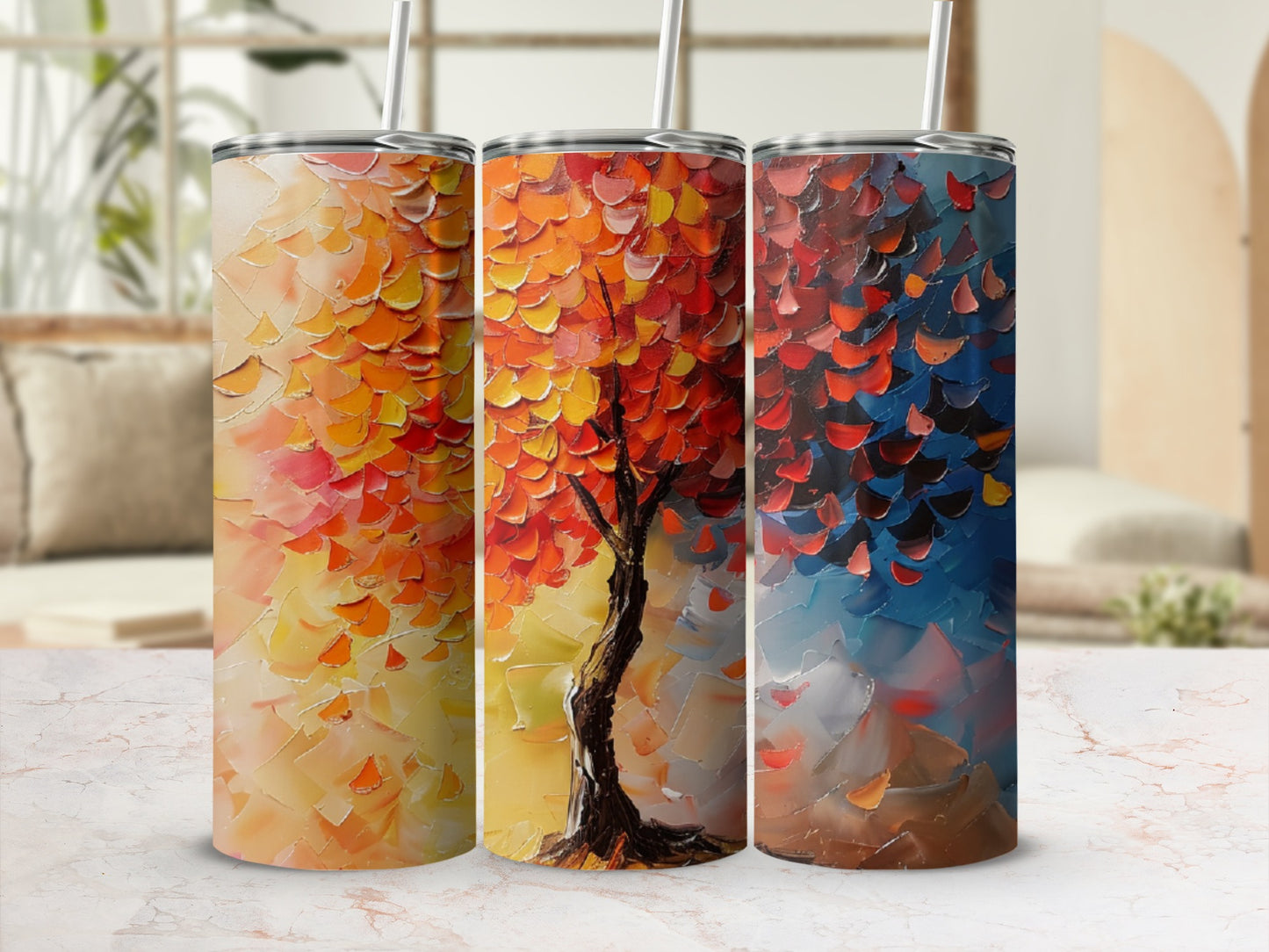 Three tumblers featuring an abstract painted tree with red, orange, and blue leaves.