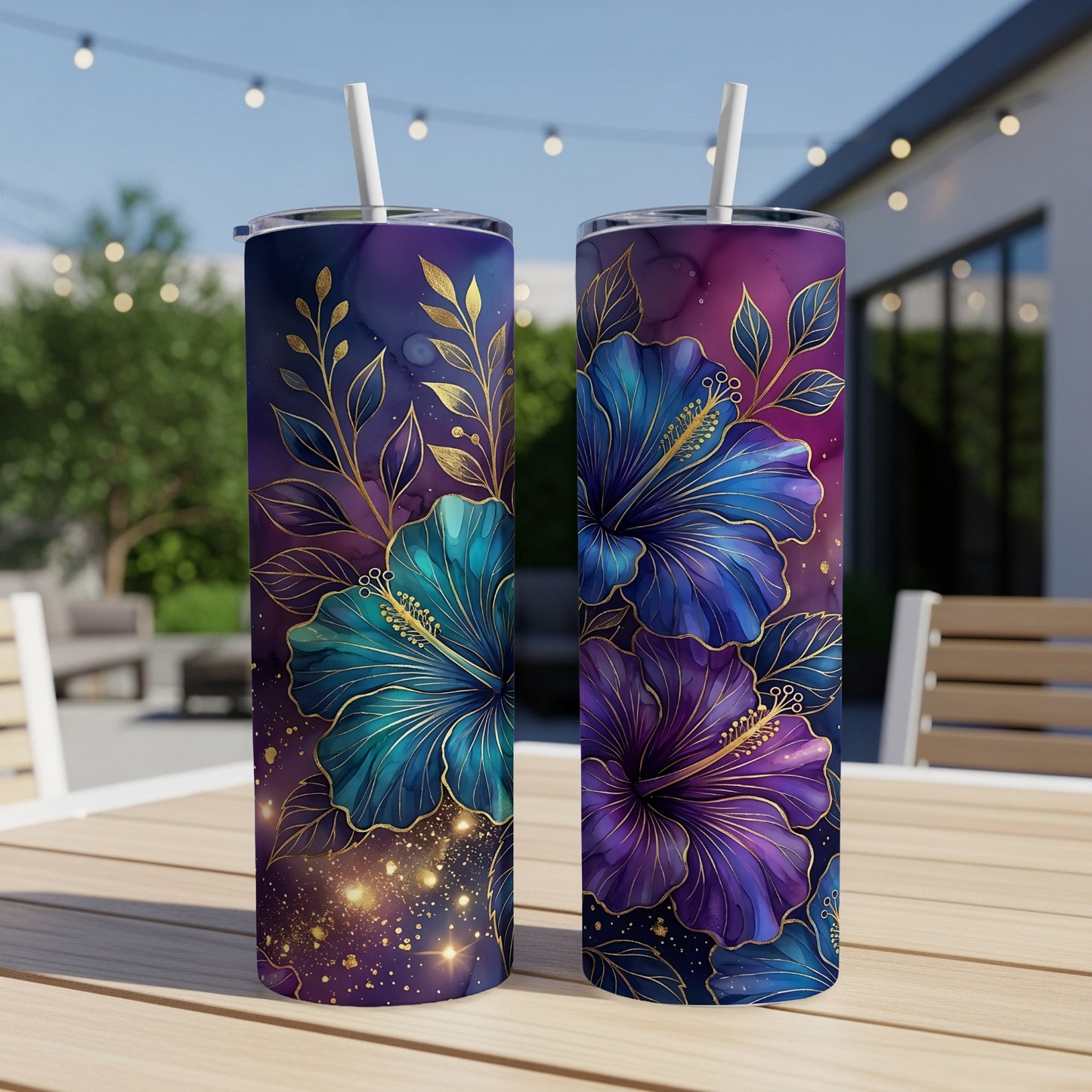 Two tall tumblers with blue and purple hibiscus flowers and gold accents.