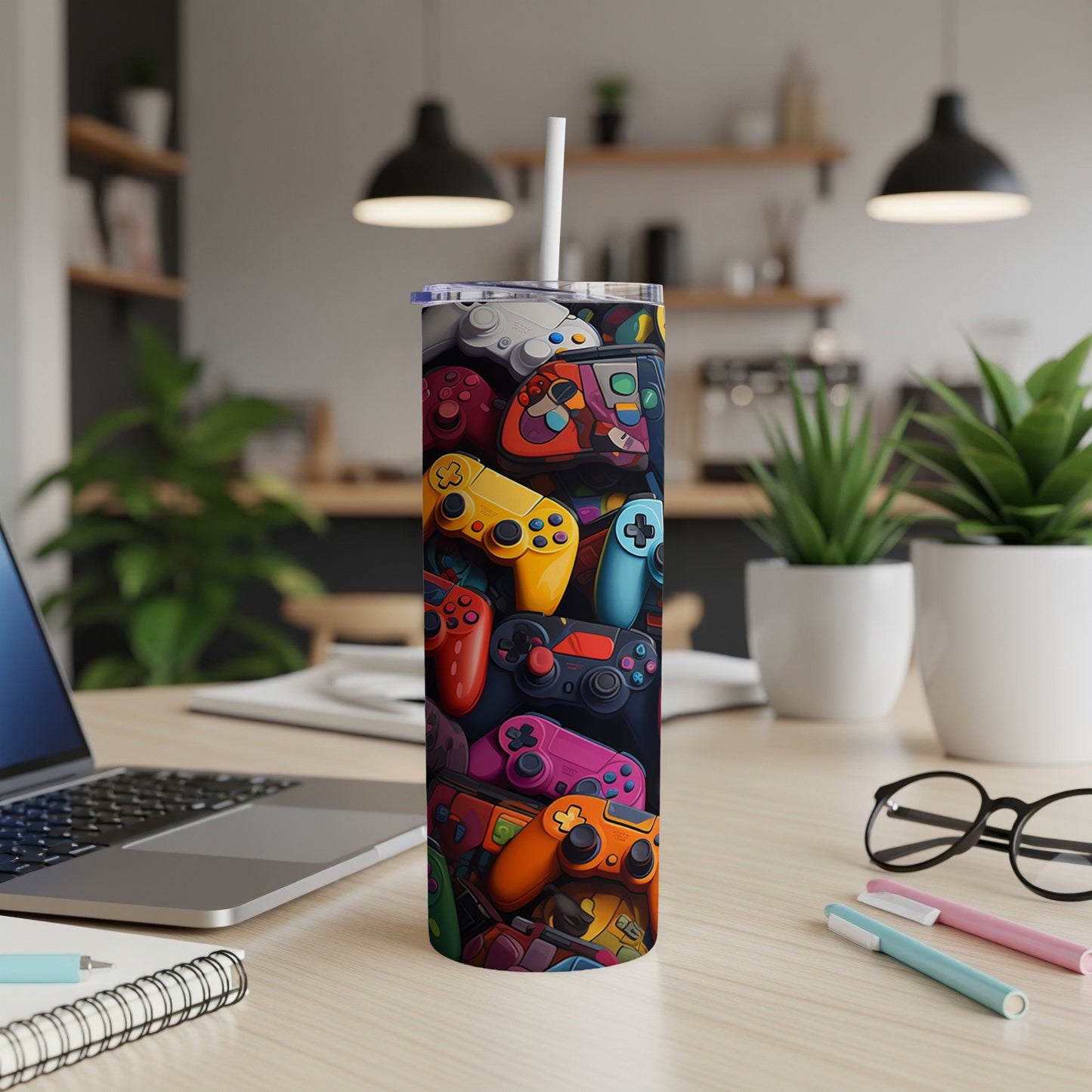 Colorful video game controllers pattern on a tumbler with a straw.