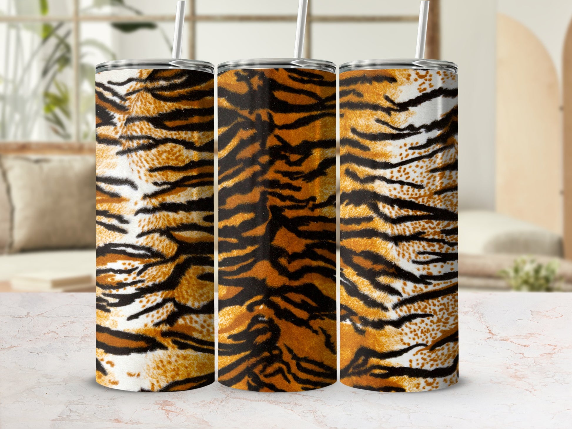 Three tumblers with a realistic tiger stripe pattern sit on a marble surface.