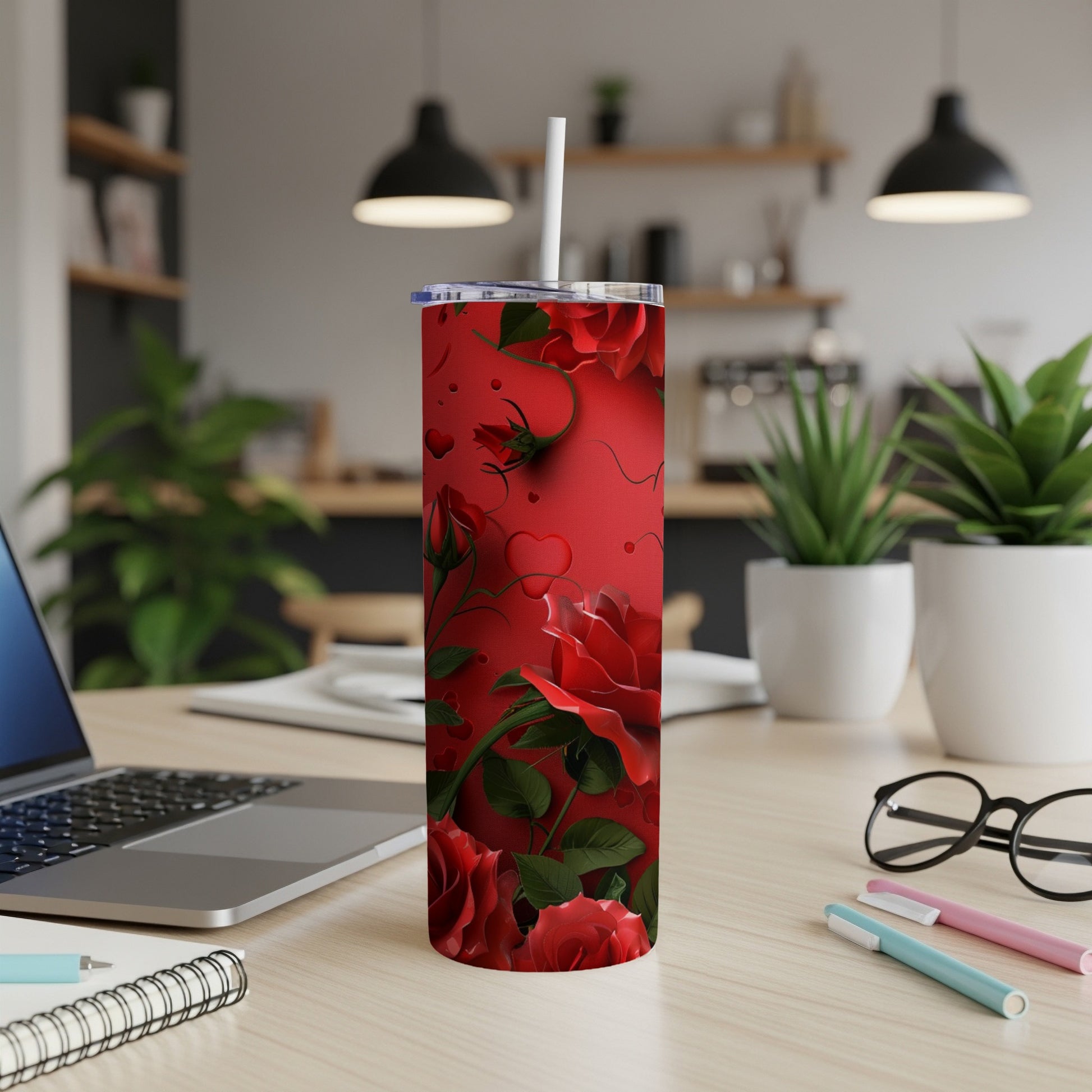 Red roses and heart pattern on a skinny tumbler with a white straw.