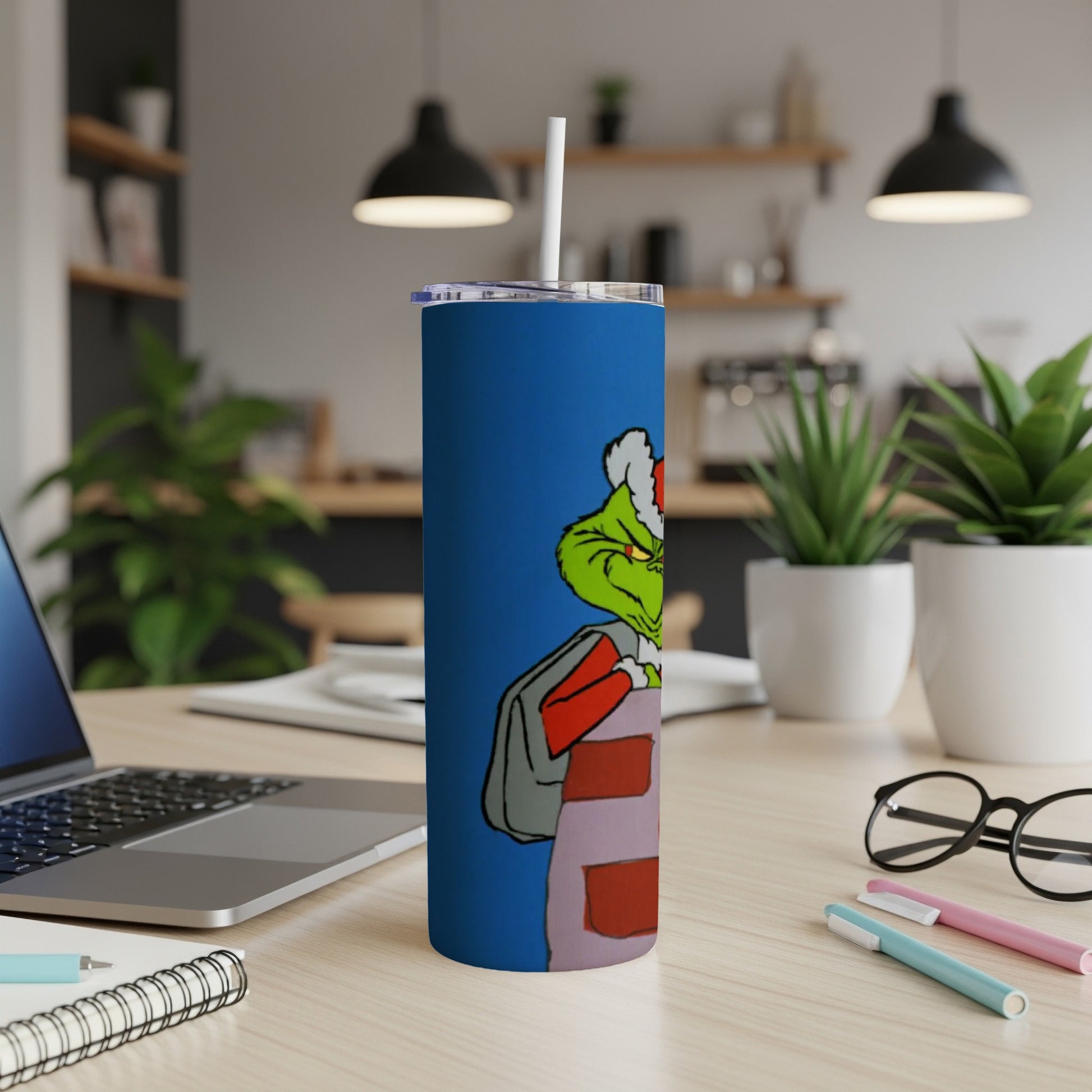 Grinch character emerging from a chimney on a blue tumbler with straw.