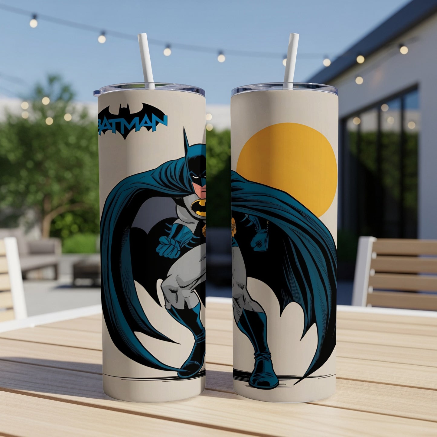 Batman illustration on two tall tumblers with straws on a table.