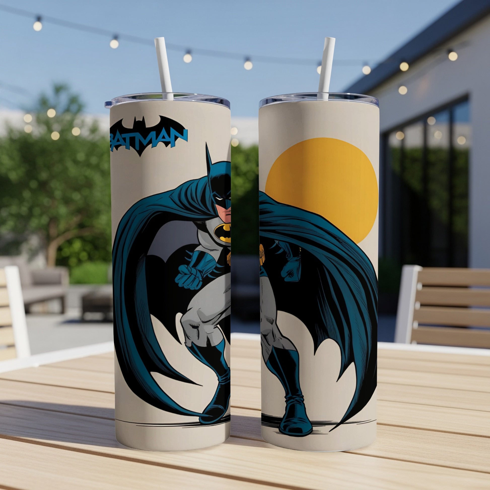 Batman illustration on two tall tumblers with straws on a table.