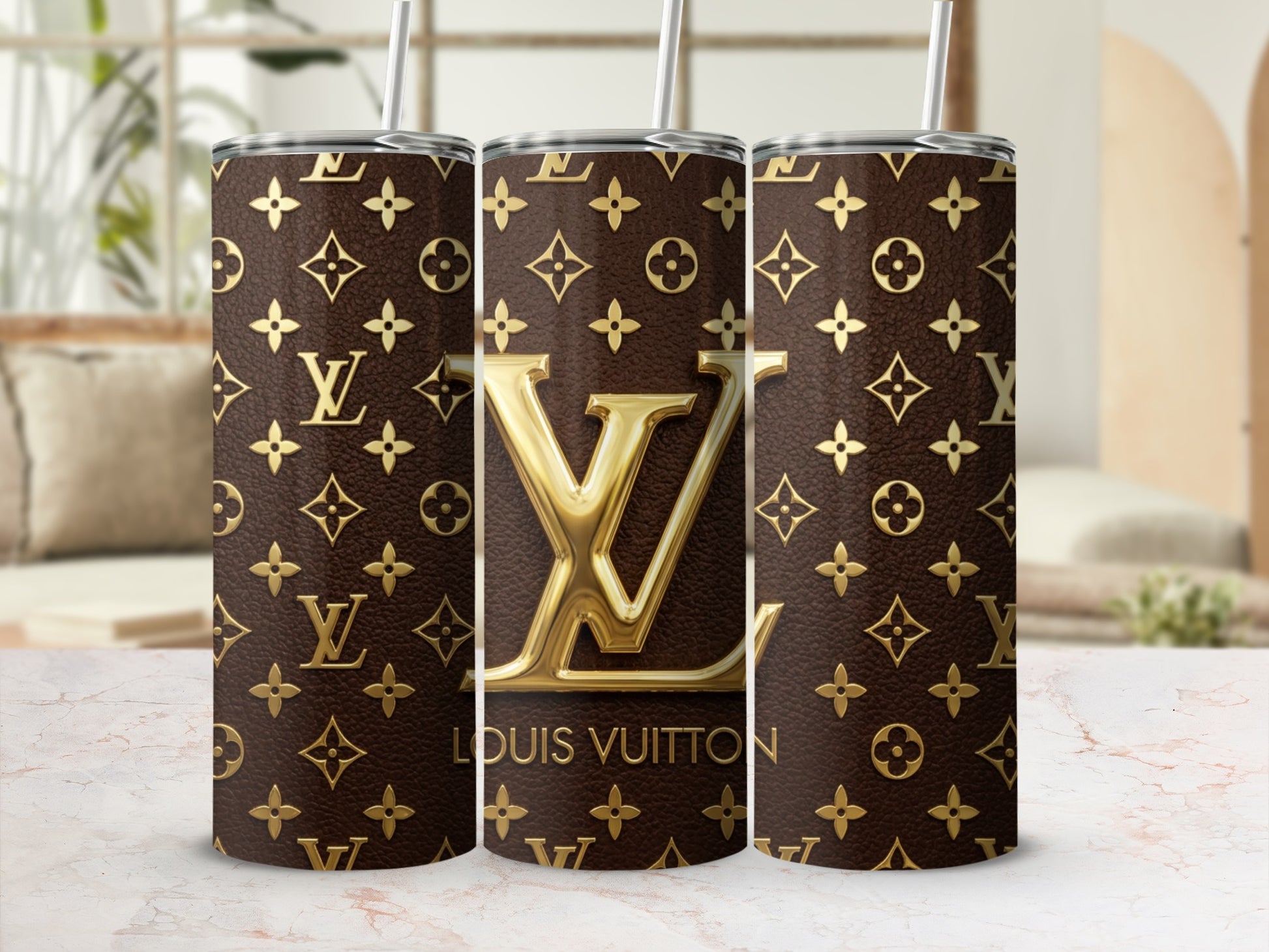 Three tumblers featuring a Louis Vuitton monogram pattern and gold LV logo.