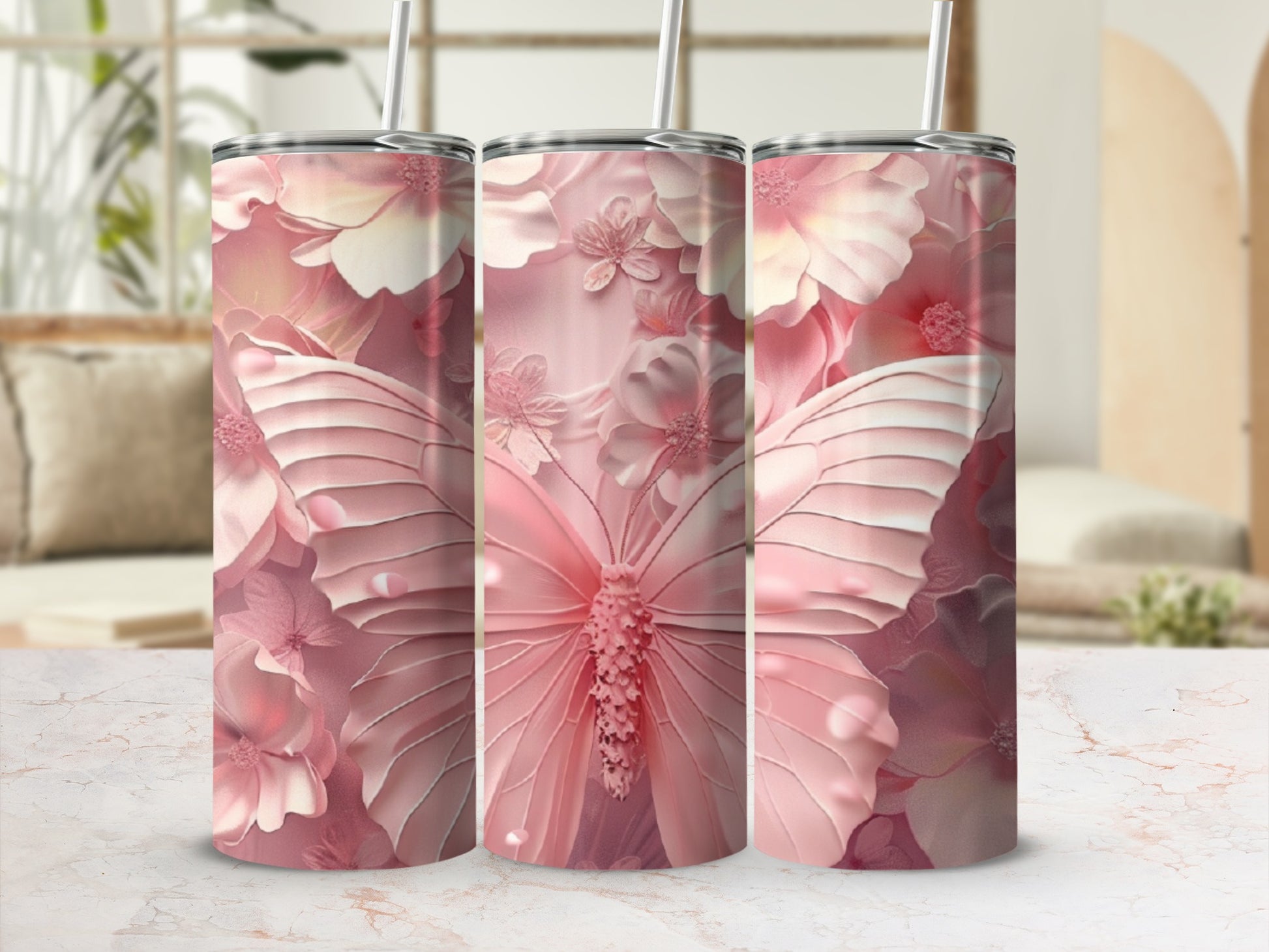 Pink butterfly and floral pattern on three tumblers with straws.