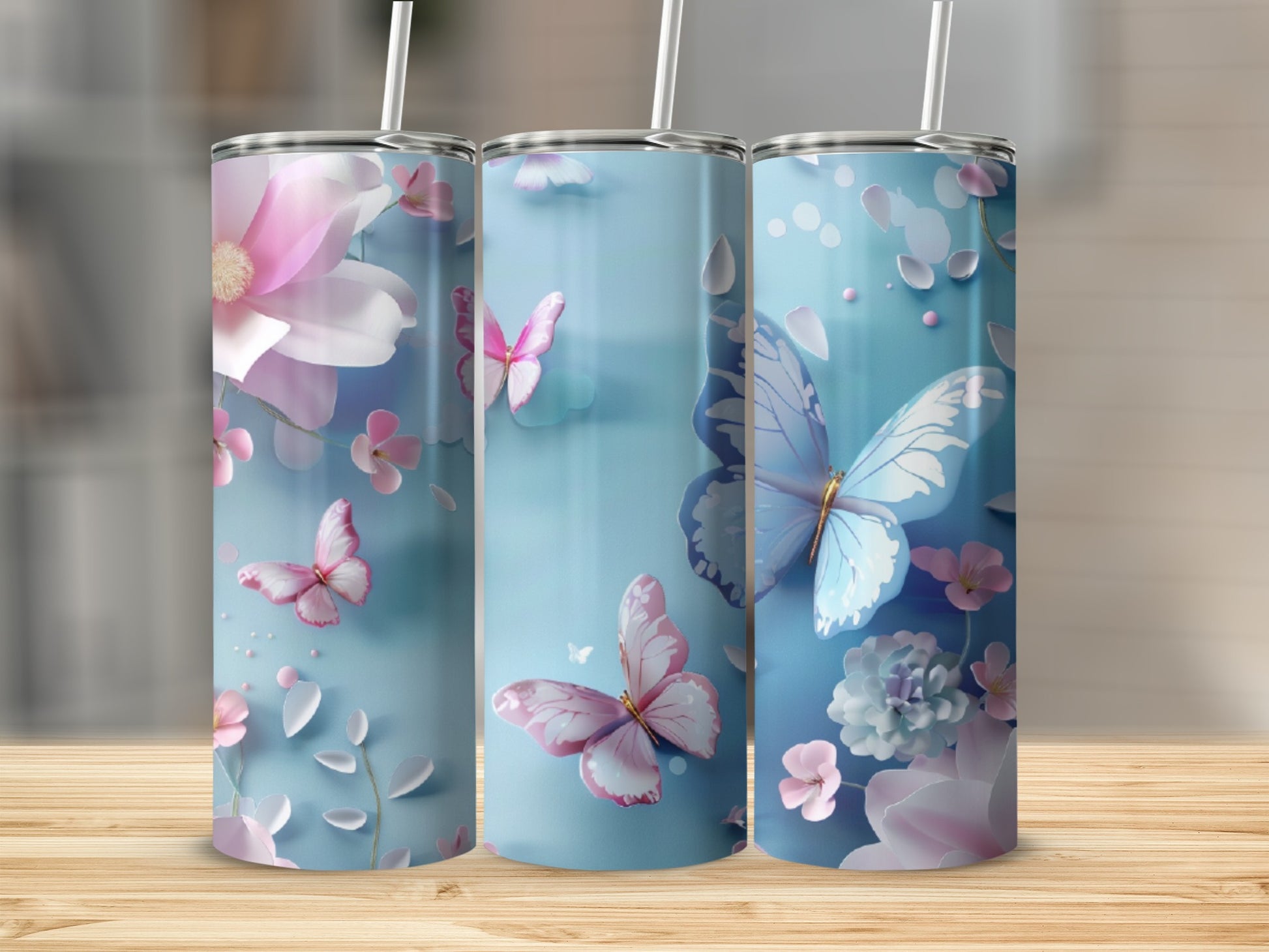 Three tall blue tumblers with pink butterflies and floral designs.