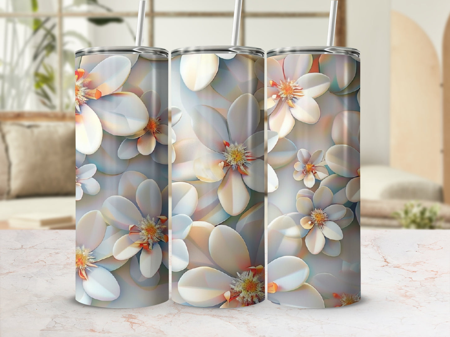 Three tall tumblers with a repeating floral pattern on a table.