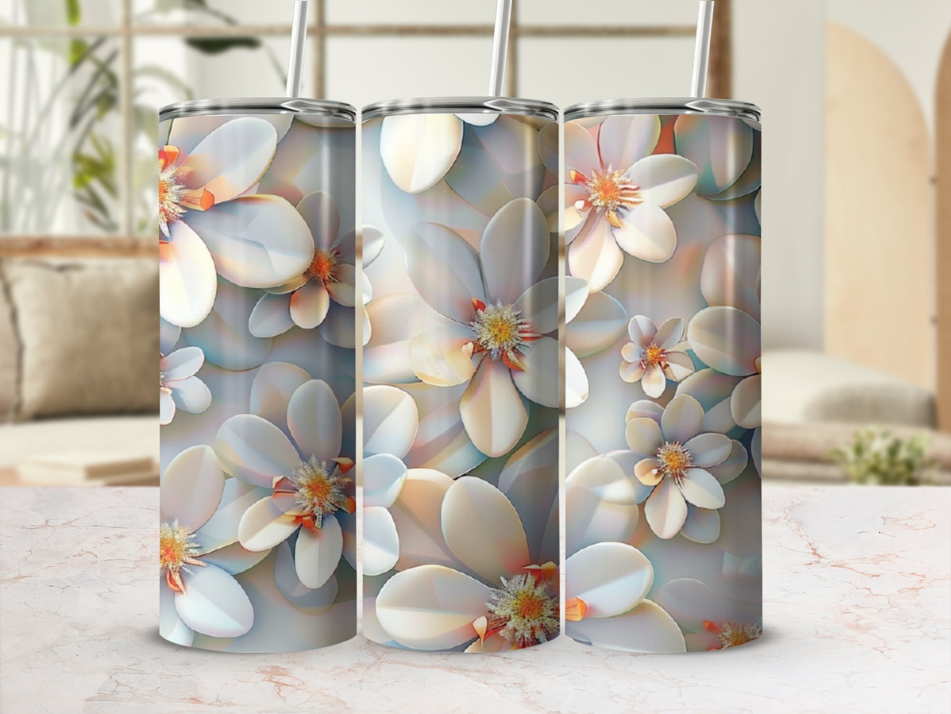 Three tall tumblers with a repeating floral pattern on a table.