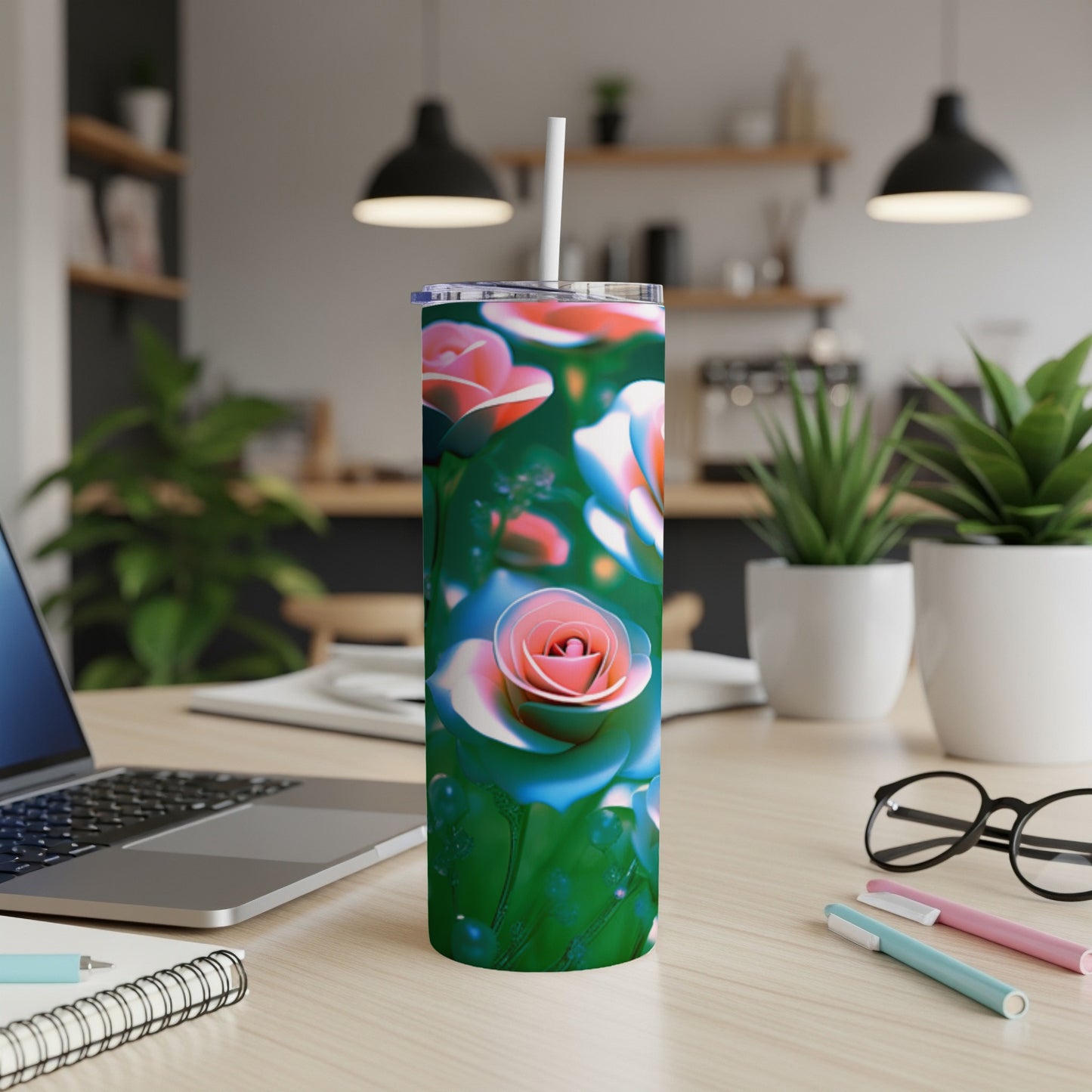 Tumbler with pink and blue roses on a grassy background.