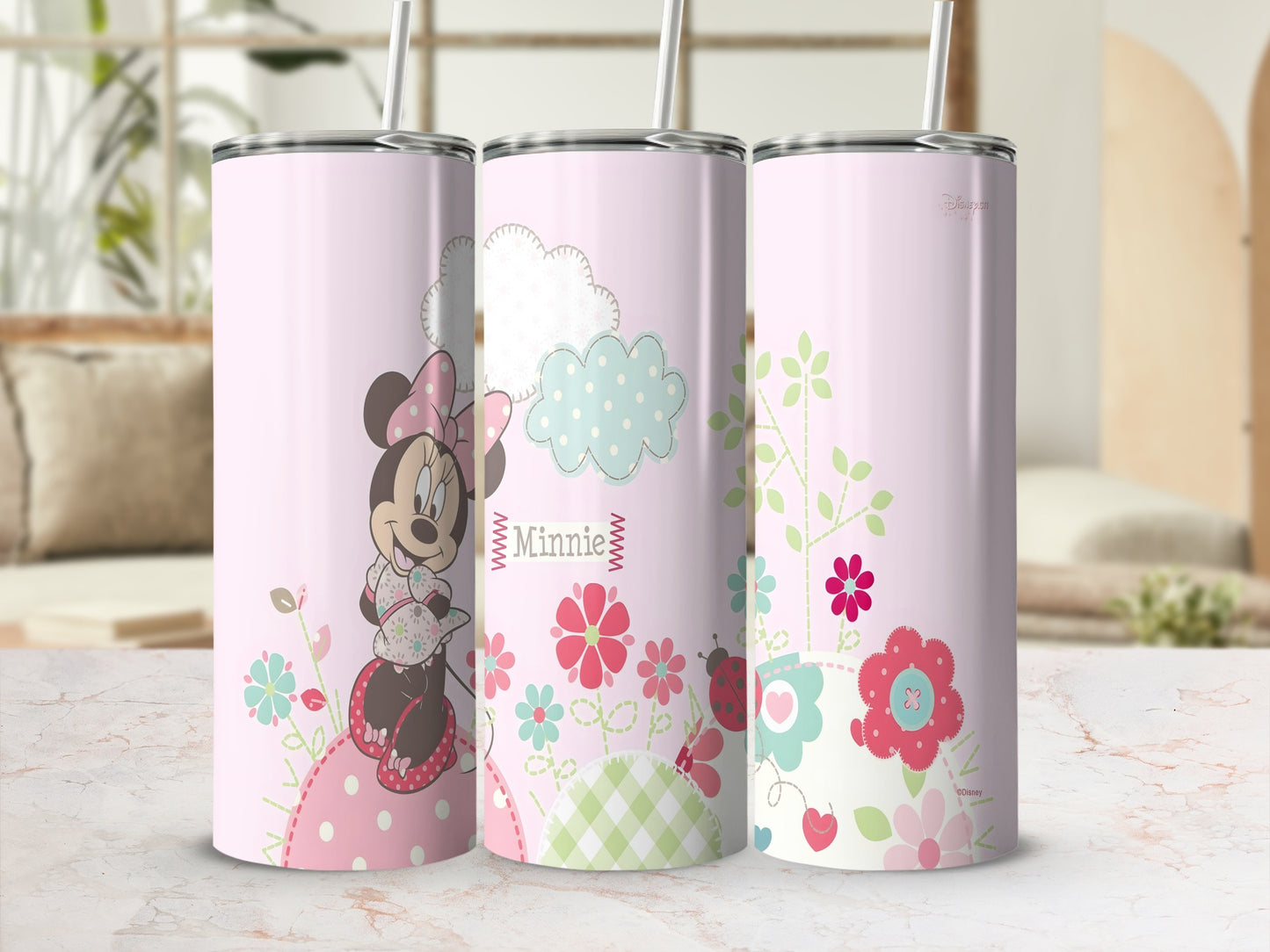 Pink tumbler with Minnie Mouse, flowers, clouds, and ladybugs.