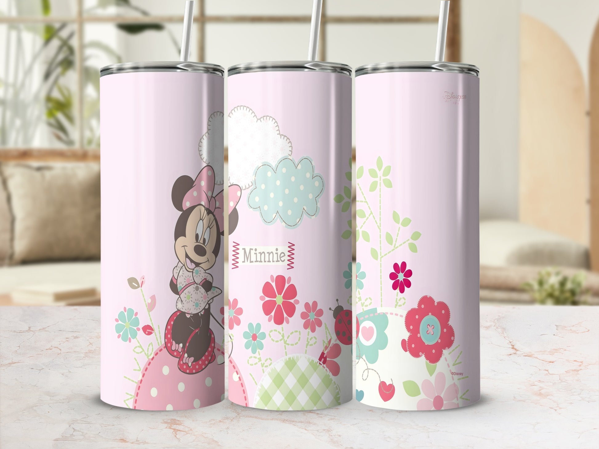 Pink tumbler with Minnie Mouse, flowers, clouds, and ladybugs.