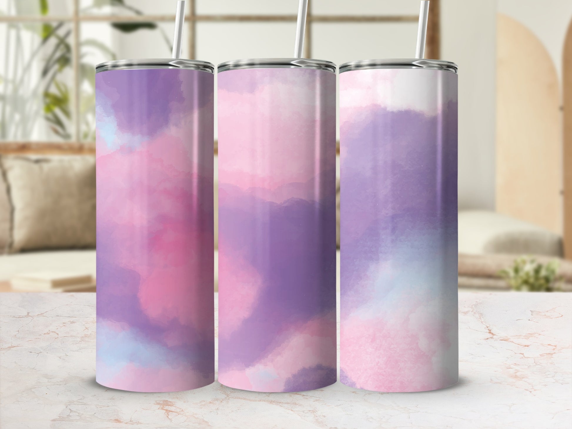 Three tumblers with abstract watercolor patterns in pink, purple, and blue.