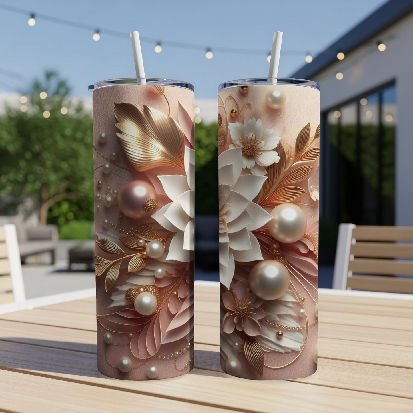 Two tall tumblers with a floral and pearl design on a wooden table.
