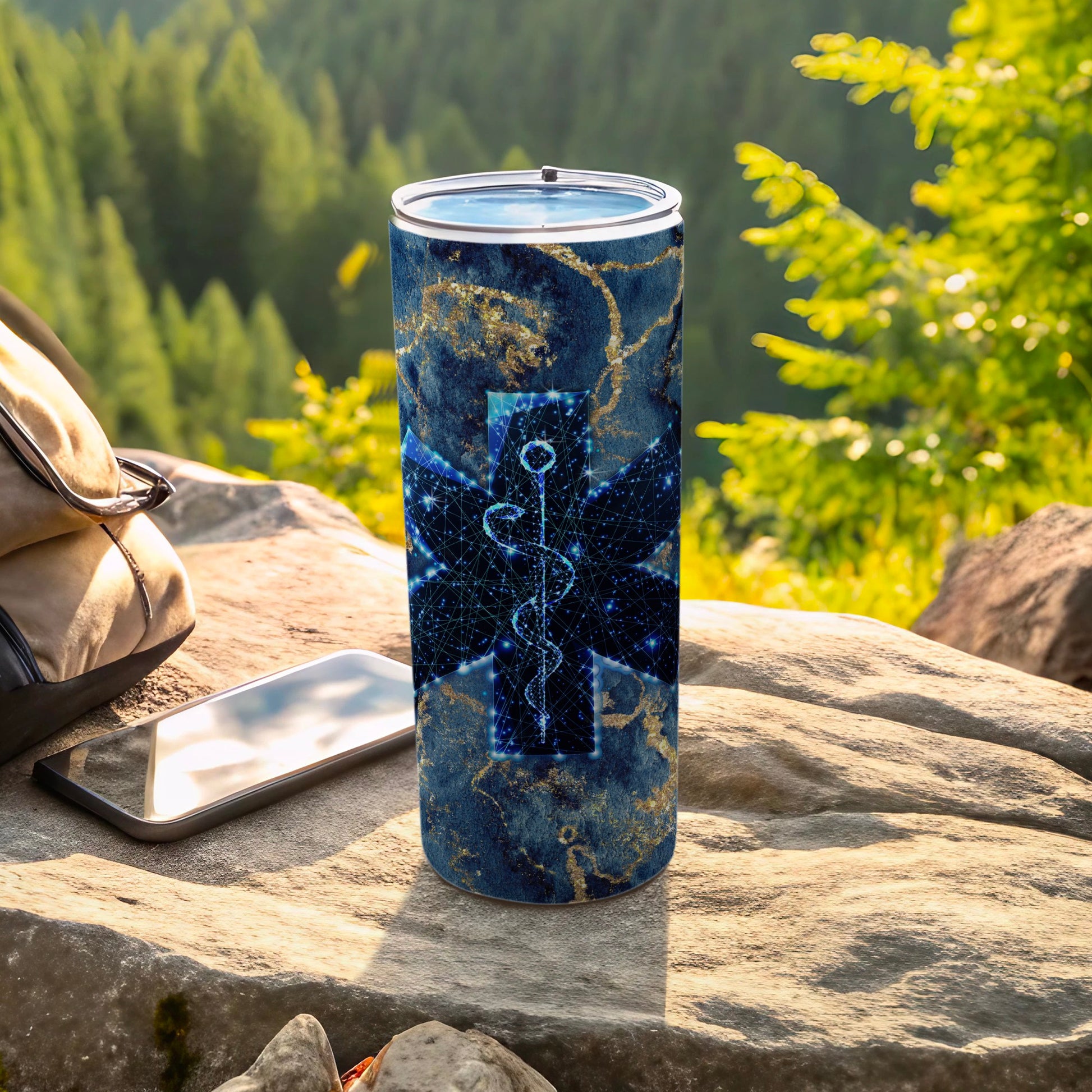 Blue marble tumbler with a digital star of life emblem, outdoors.