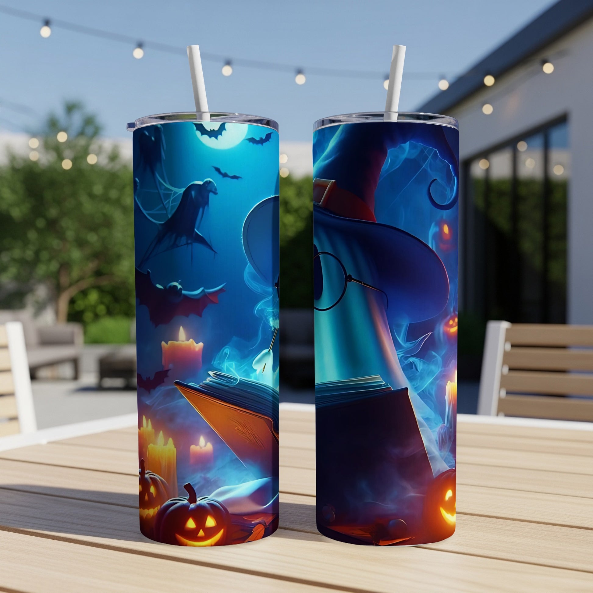 Two tumblers with a Halloween witch and book design on a table.