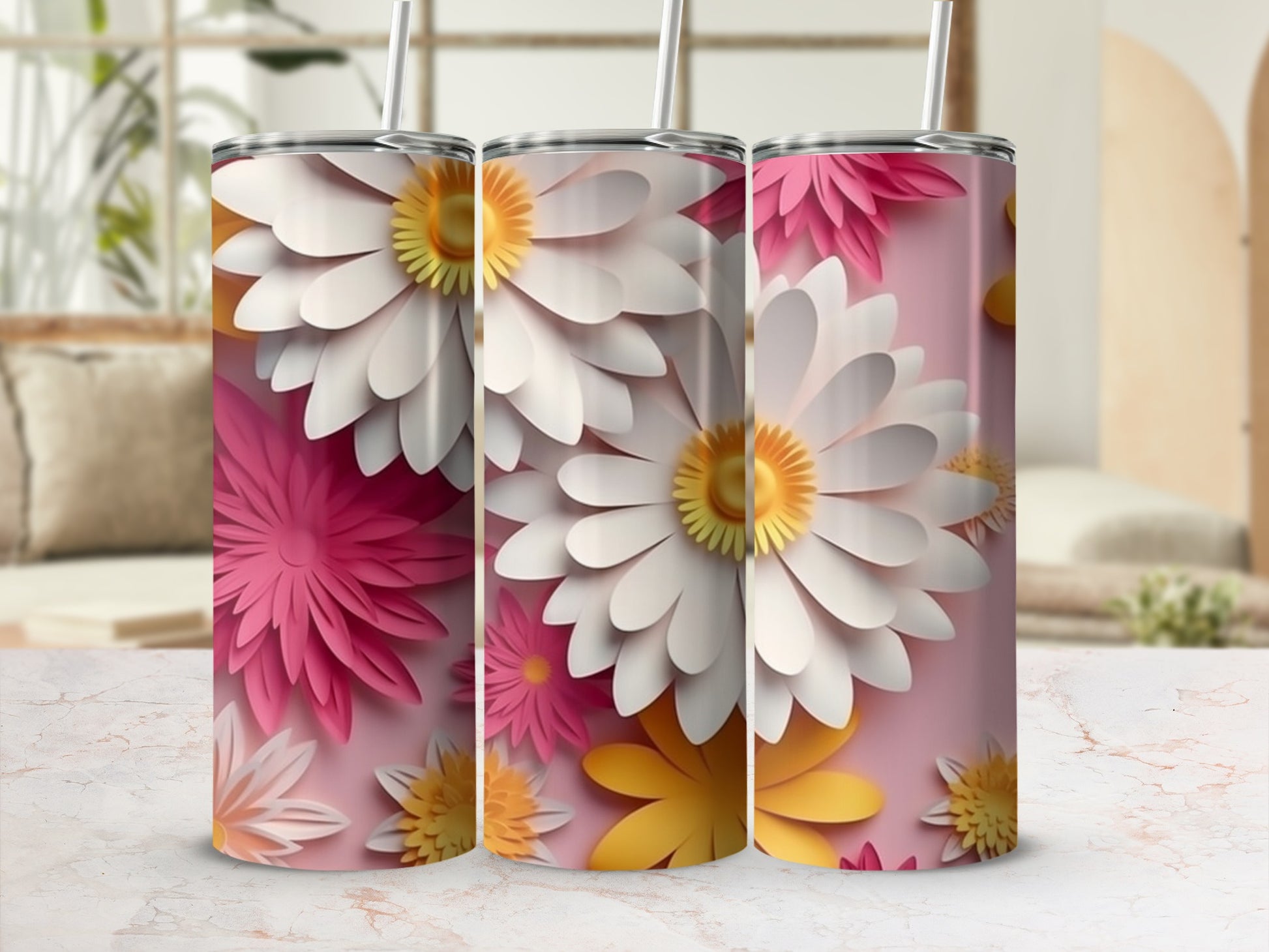 Three 3D floral print tumblers with straws on a patterned surface.