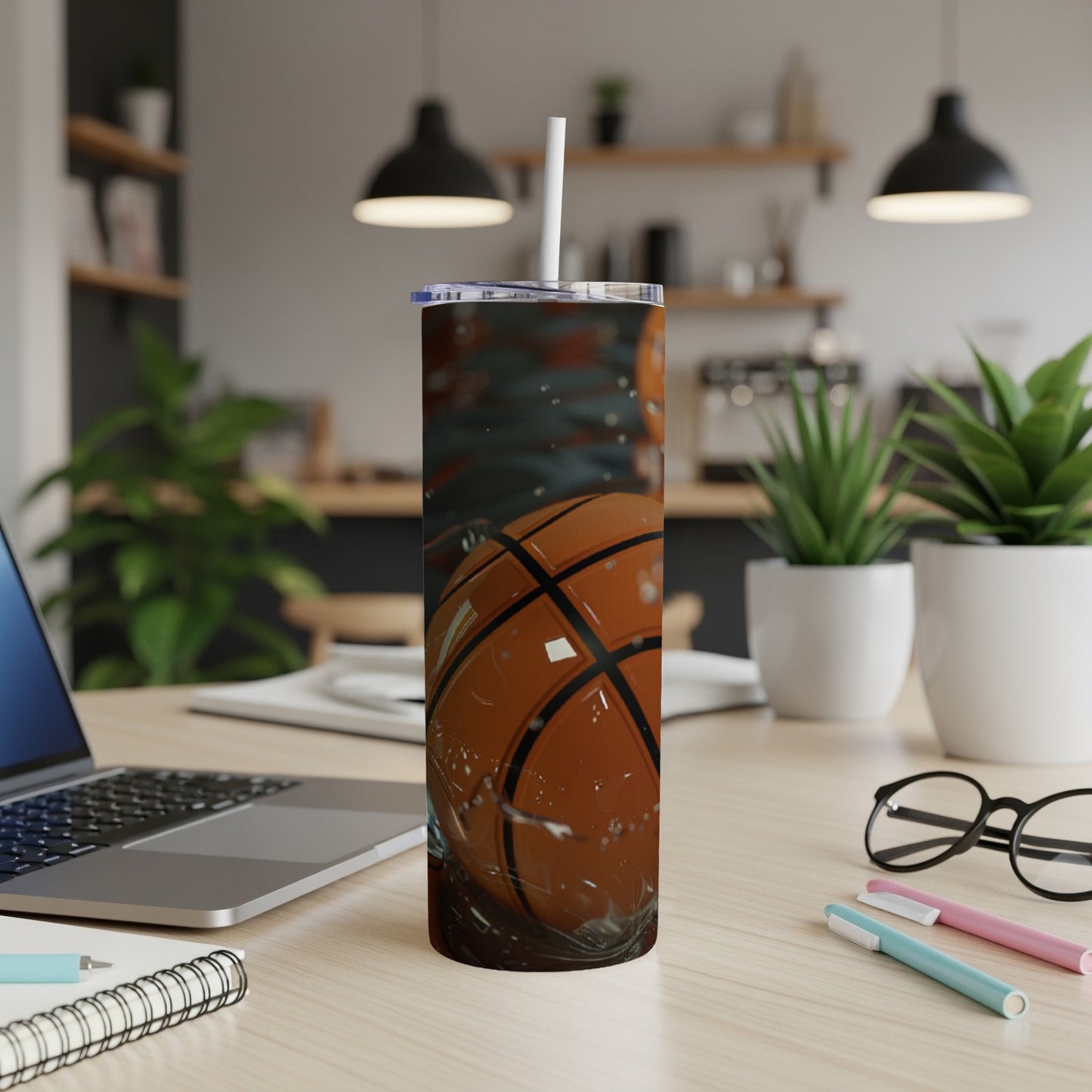 Basketball tumbler with a straw in a kitchen setting.