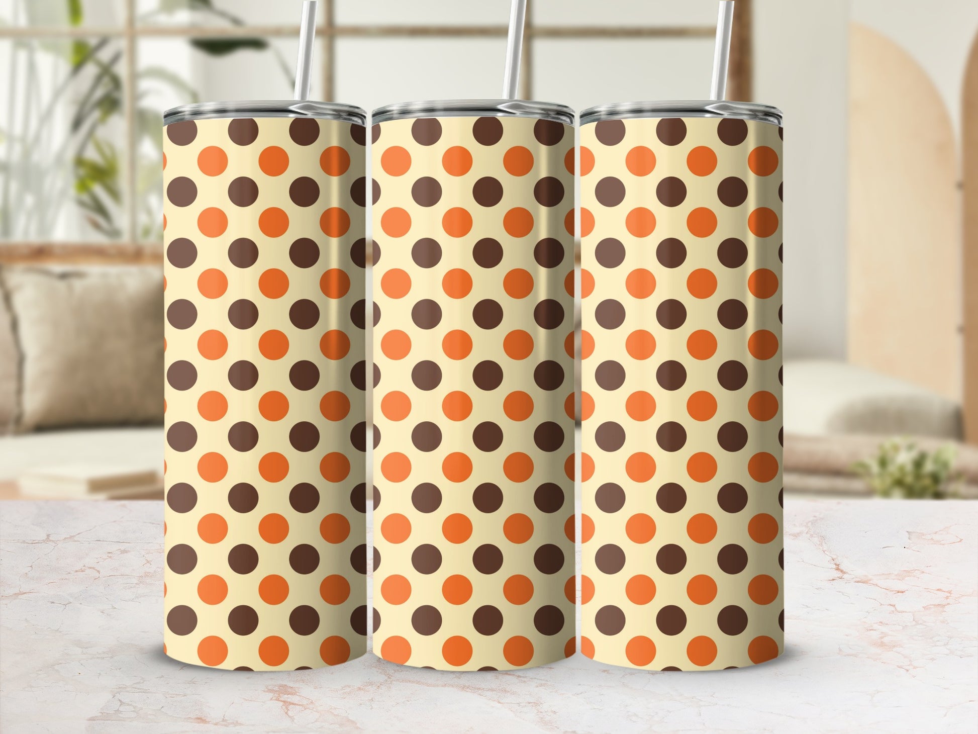 Three tumblers with a light cream background and brown and orange polka dots.