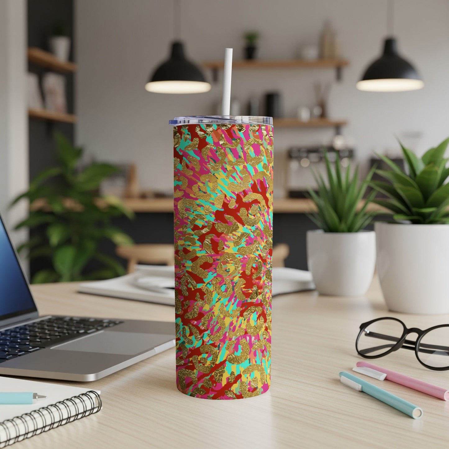 Tumbler with a vibrant red, teal, yellow, and gold abstract animal print design.