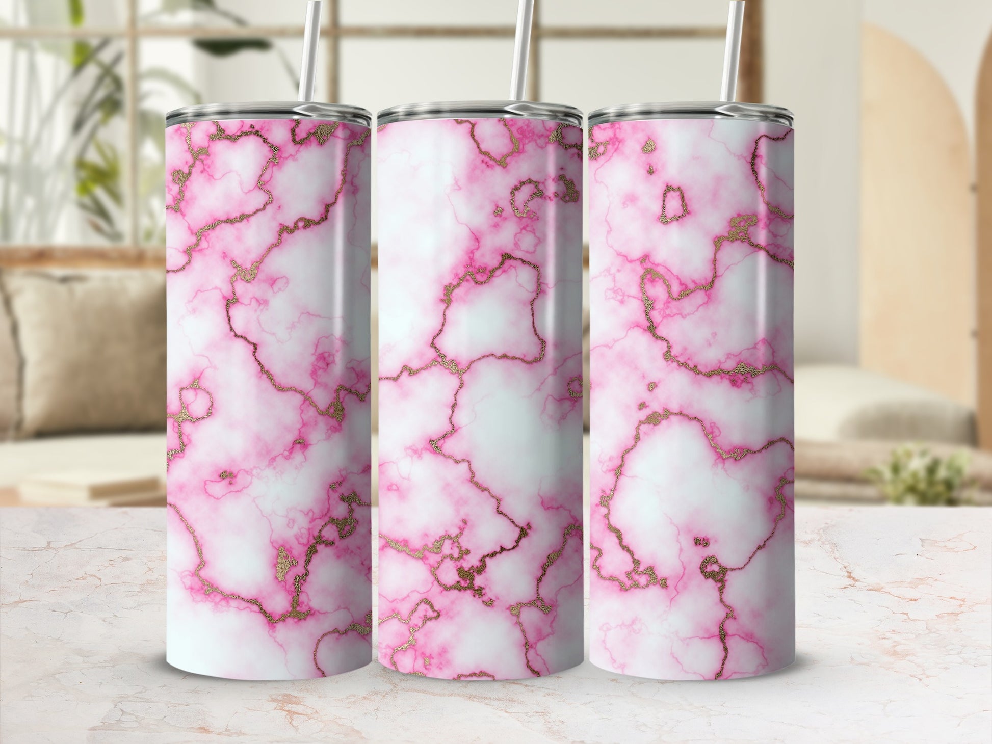 Pink and gold marble pattern on three tumblers with straws.