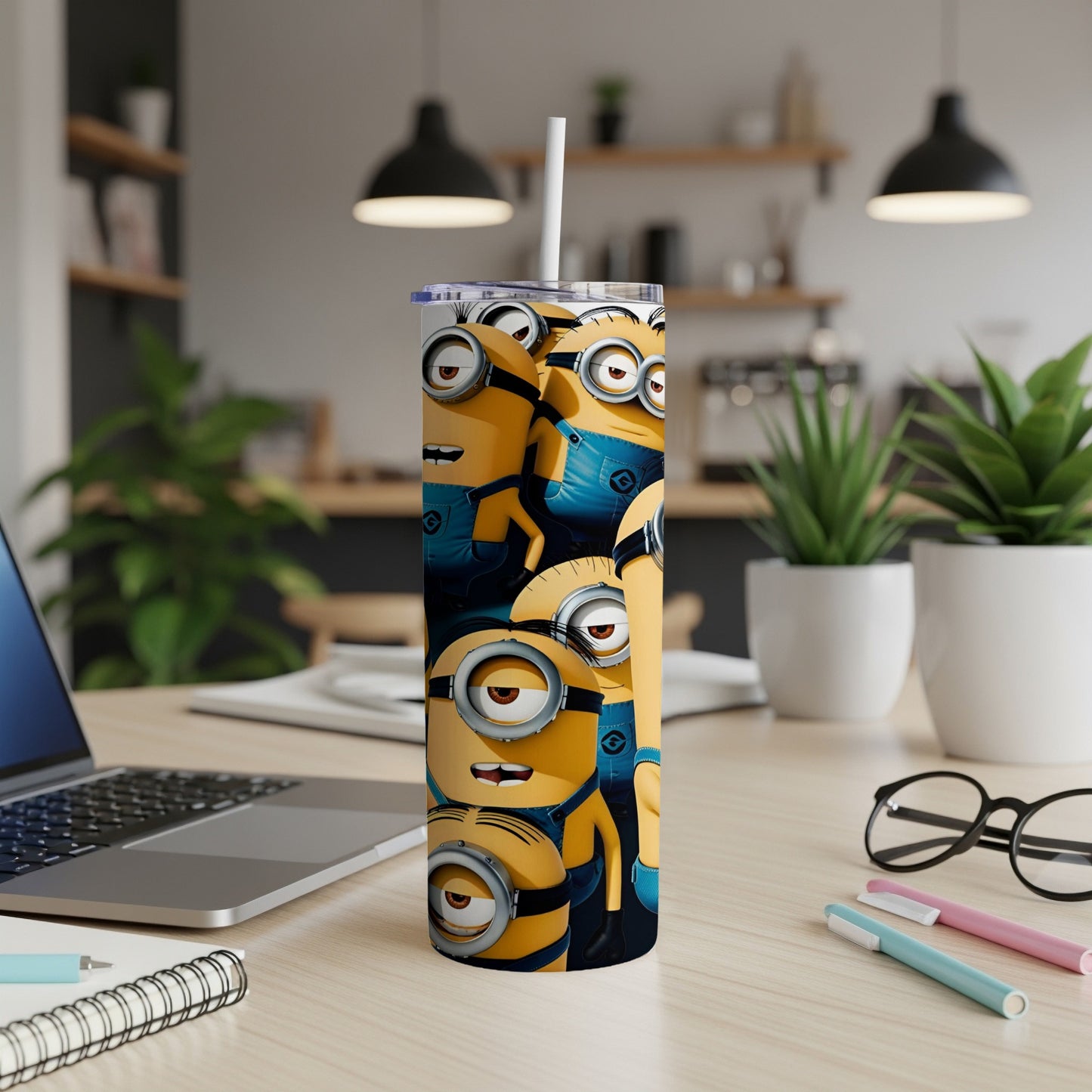 Minions characters on a yellow and blue tumbler with a white straw.