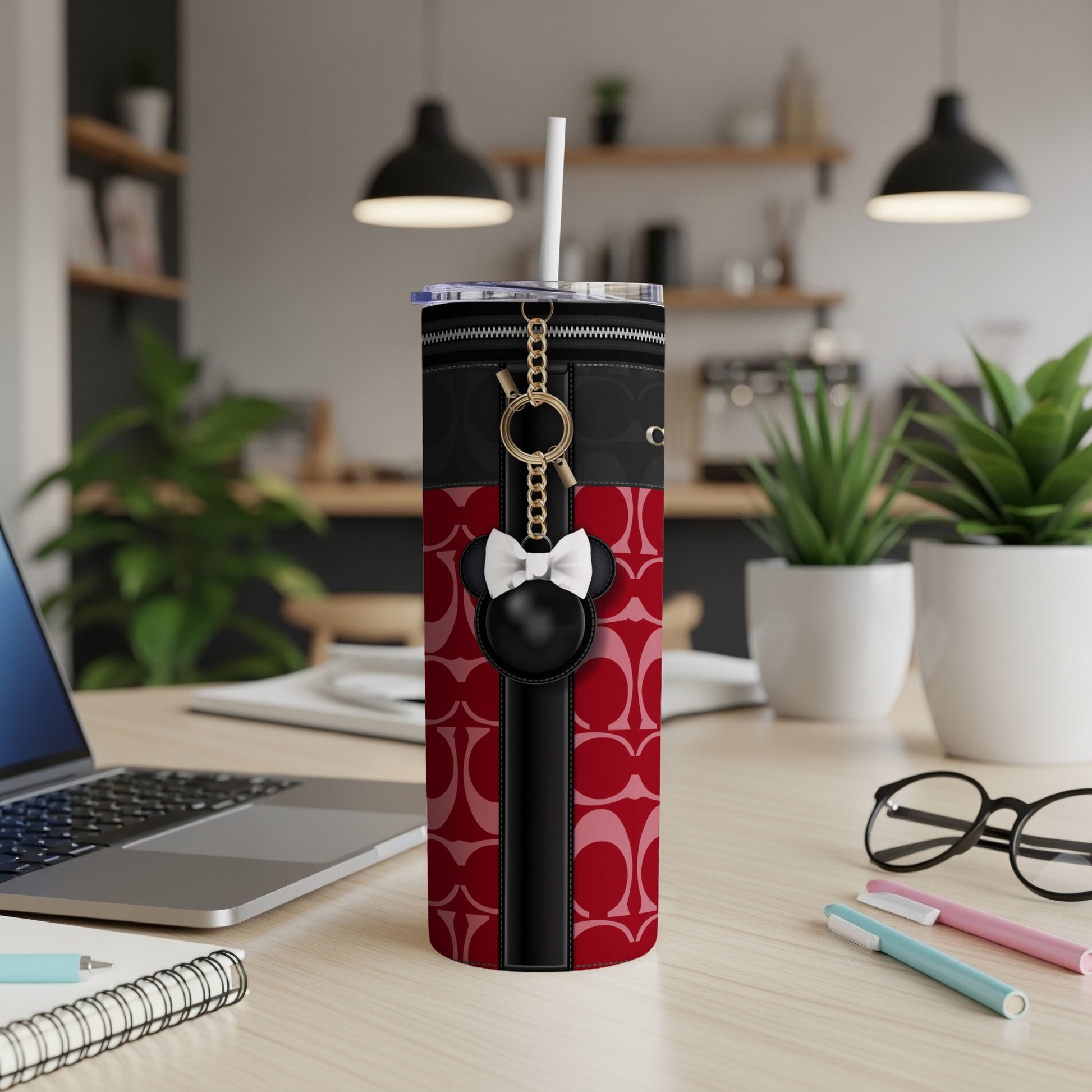 Tumbler with red and black pattern, zipper detail, and Mickey Mouse charm keyring.